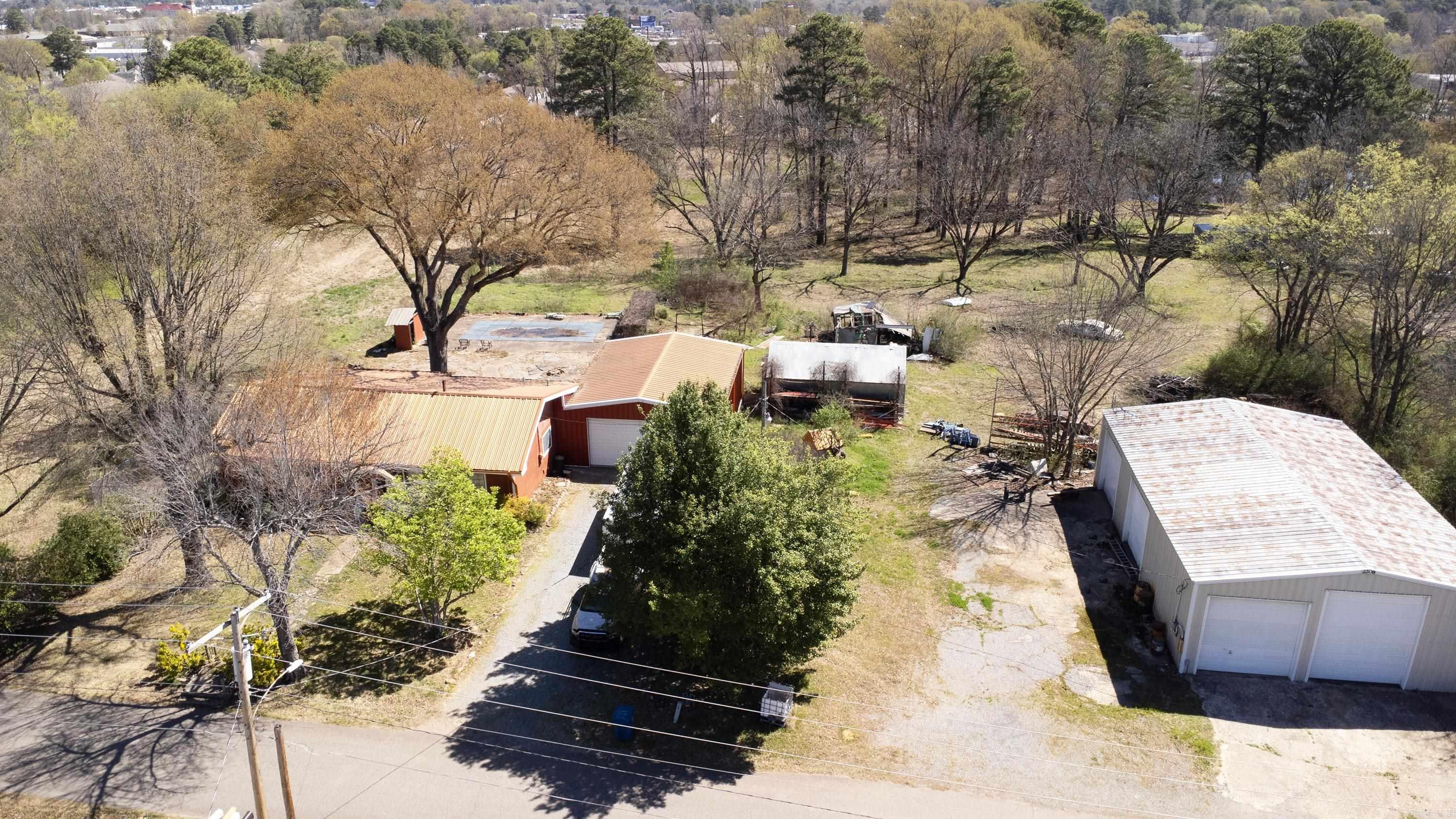 10 acres of C2 land off spring hill road. With two storage buildings and a paint shop on site. Has a home with a pool also included. Home is on septic. Land has access to city water and sewer. Great area for community buildings. Come see today.