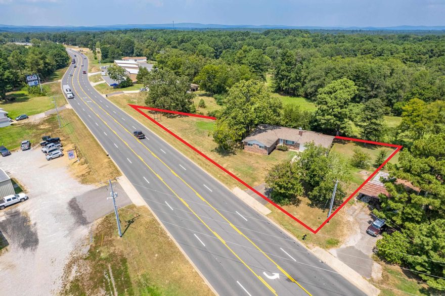 Excellent commercial potential in a rapidly growing area! Located less than a mile from Lake Hamilton School, this property offers outstanding visibility and convenient access. The 1,828 sq. ft. home features 3 bedrooms, 2 baths, and a fenced backyard, making it ideal for residential use, rental income, or office conversion. With plenty of room for parking or future development, this property is a rare opportunity for investors or business owners to secure a prime location in a high-traffic corridor.