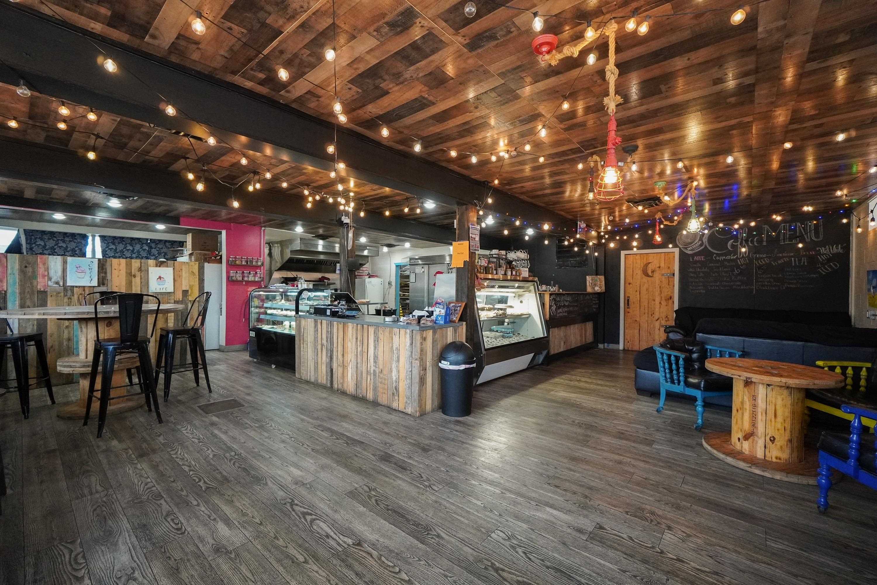 This versatile commercial building, currently operating as a bustling coffee shop, offers a unique investment opportunity in a high-traffic area. With its inviting storefront and modern interior, the property is perfectly suited for a variety of business ventures.