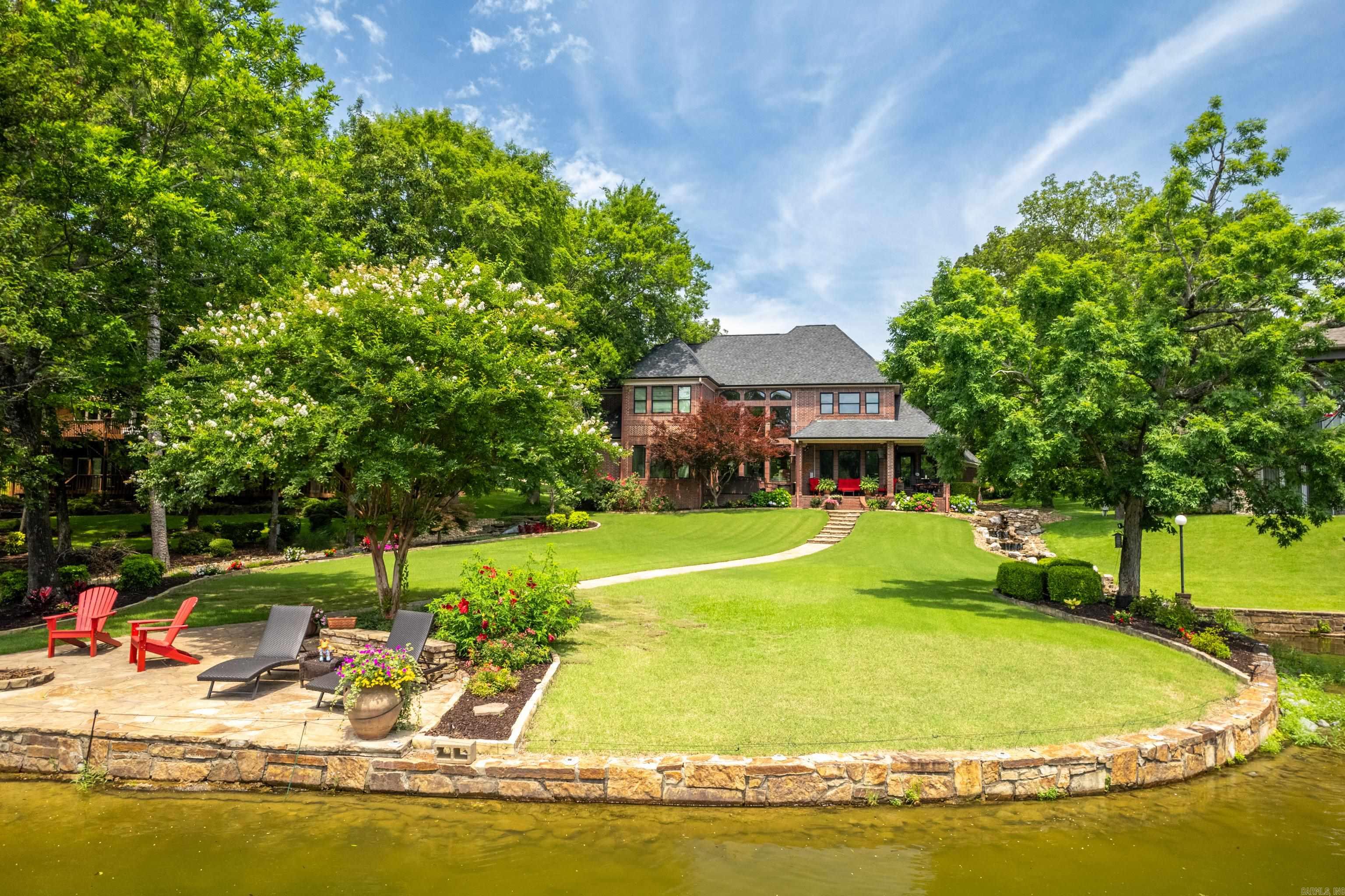 Exquisite Lakeside Living in Prestigious Stonegate Shores! Discover an exceptional opportunity to own a beautifully appointed 5-bedroom, 3.5-bath waterfront estate on the serene shores of Lake Hamilton. Set on a meticulously manicured, level lot in the prestigious gated community of Stonegate Shores, this home blends sophistication, comfort, and the ultimate lake lifestyle. Enjoy a spacious main-level primary suite, formal dining room, great room, separate living room, and a gourmet eat-in kitchen designed for both everyday living and entertaining. An oversized 3-car garage offers plenty of space for vehicles and lake gear. Step outside to your private oasis with a professionally landscaped backyard, tranquil water feature, fire pit, and direct access to a 2-slip covered boat dock in a peaceful no-wake cove with boat launchāperfect for swimming, boating, or simply relaxing. Recent upgrades include new insulated windows and a new roof (Dec 2023). Just minutes from all that Hot Springs has to offer, this is lakeside luxury at its finest! Schedule your showing today!