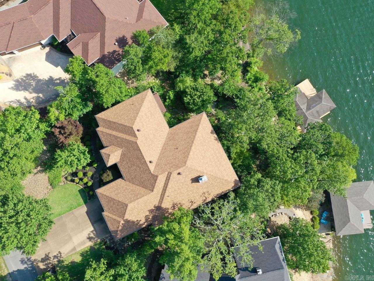 An incredible opportunity on Lake Balboa. This expansive 5/6 bedroom home has two kitchens and can live like two separate homes. Perfect for big groups or families with room for everyone to spread out and live large on the lake. The main level includes a family room, living room, dining room, extra large kitchen and breakfast room, laundry and two car garage. There is an spacious primary suite, half bath for guests and two additional bedrooms with a jack & jill bathroom. One has been used as an office and has it's own separate deck. Speaking of decks. Both levels have an huge covered deck looking over the lake and boat dock. Downstairs is a convenient kitchen, dining area, large den or game room, three bedrooms and a full bath. There is a massive storage area 74 feet long, that has outside entrance. There is also a 17 x 12 heated and cooled bonus room off the storage area with large windows looking out on the lake. Truly one of a kind. You must see this for yourself! There is a recent inspection report at the home and available online.