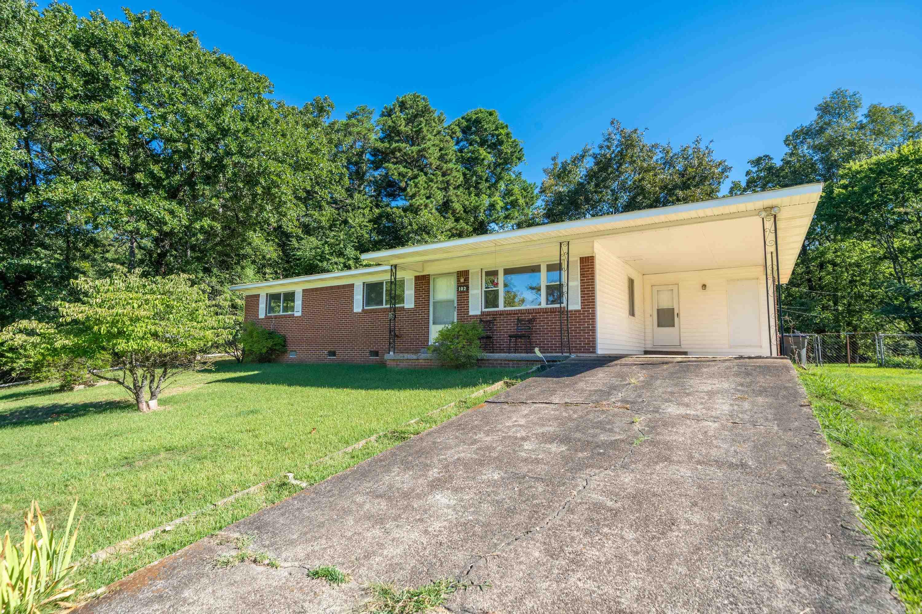 This 3 Bed/1.5 Bath beauty is nestled in a quiet neighborhood in Hot Springs School District. Open & airy floor plan with updates galore. Gas cooktop in kitchen, fresh paint throughout, & every room floored with beautiful original hardwood flooring. Plenty of room for the kids (and adults) to play in the privacy-fenced back yard! Relax & entertain guests on the large patio & blooming trees. Large shop w/carport in the back perfect for projects! So much character in this darling home.
