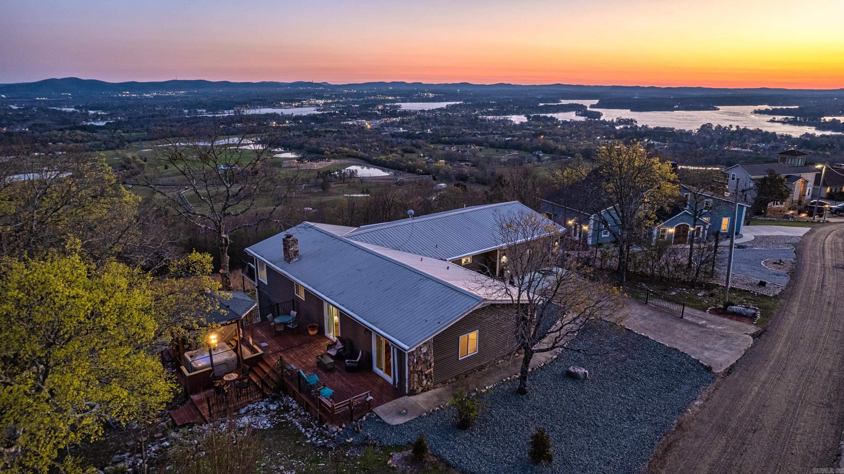 Offering Sweeping Views of Lake Hamilton, the City of Hot Springs and the Ouachita Mountain Range! Eagle's Nest is Perched on Mt. Riante and features an Open Floor Plan that is Perfect for Entertaining, with Walls of Windows to Enjoy Nature with each changing Season! The Kitchen, Dining and Living Room (with Natural Stone Fireplace) are the Heart of the Home! There are 2 Primary Suites and 2 Guest Rooms as well that share a Full Bath. Plenty of Room for Large Families and Friends to Gather! The Outside Entertaining Areas include a Private Side Deck with a Hot Tub, Al Fresco Dining and a Custom Firepit. This is currently a Short Term Rental, but would make a Great Home for Full Time Living as well! This Home is Selling Fully Furnished. Call Today for More Information