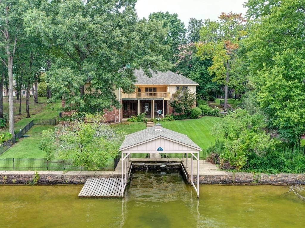 Spacious Lake Hamilton home sitting in gated Driftwood Point.  This home features 4  bedrooms, 3 1/2 baths,  multiple entertaining areas, open floor plan, covered boat dock and much more.