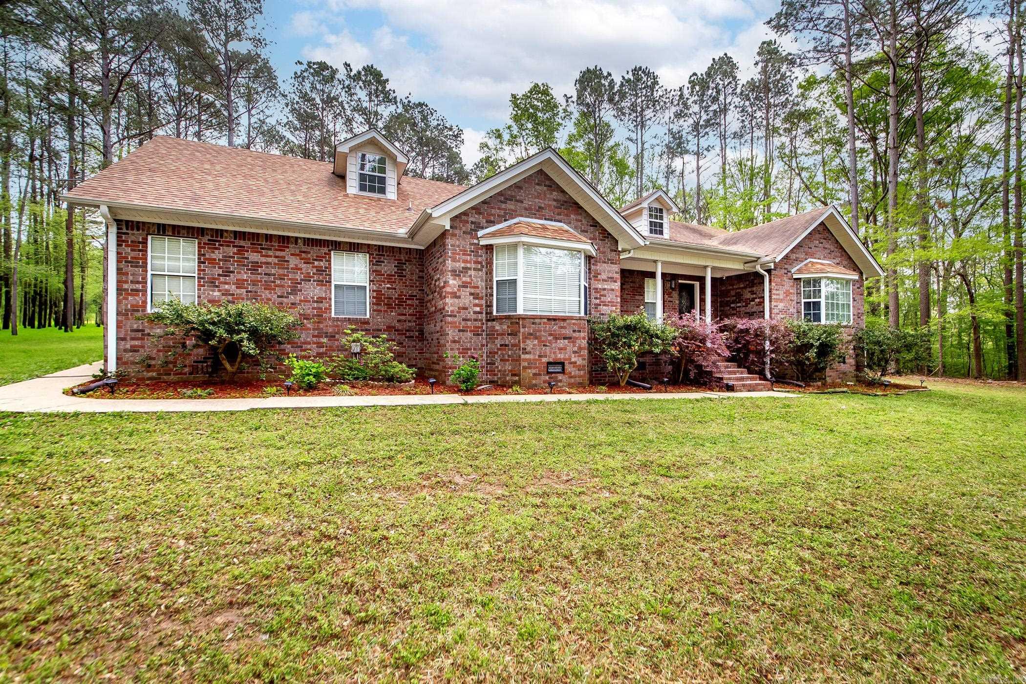 Tucked away on 1.5 peaceful acres, this beautifully updated brick home blends country charm with city convenience in Arkadelphia. Inside, a cozy living room features built-ins and a wood-burning Buck Stove, with French doors opening to a large deck and private backyardāperfect for relaxing or entertaining. The country kitchen boasts butcher block countertops, a deep sink, tile backsplash, and custom cabinets, with a sunny breakfast nook and a formal dining room. The oversized primary suite offers a walk-in closet, en-suite with jetted tub and separate shower, plus access to a bright sunroomāideal for a home office or studio. Enjoy a spacious game room with wet bar, and an oversized two-car garage with plenty of storage. Updates include a new roof, 2 HVAC units, Sensi smart thermostats, stainless appliances, LED lighting, and more. Move-in ready and full of charmāthis one is a must-see! Call today for your private showing.