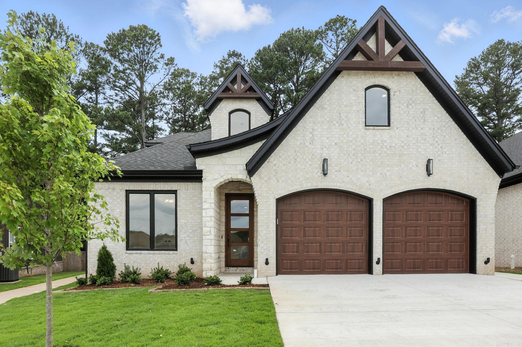 The one you have been waiting for! Welcome to 6 Woodlands Park Lane, a designer-curated masterpiece that redefines luxury. This home is the crown jewel of the neighborhood, offering unmatched craftsmanship, design, and functionality. As one of the last new construction opportunities in this sought-after Woodlands Park community, this home truly embodies āsaving the best for last.ā Perfectly situated on one of the largest lots, enjoy serene views of mature trees from your covered patio, all while never mowing again, thanks to included lawn care. Inside, grand 18-foot ceilings greet you as you enter the foyer and an open-concept layout makes a bold statement, with designer touches around every turn. Featuring 3 bedrooms and 2 full baths on the main level, plus a bonus room, 4th bedroom, and full bath upstairs, this home offers the perfect blend of space and style.