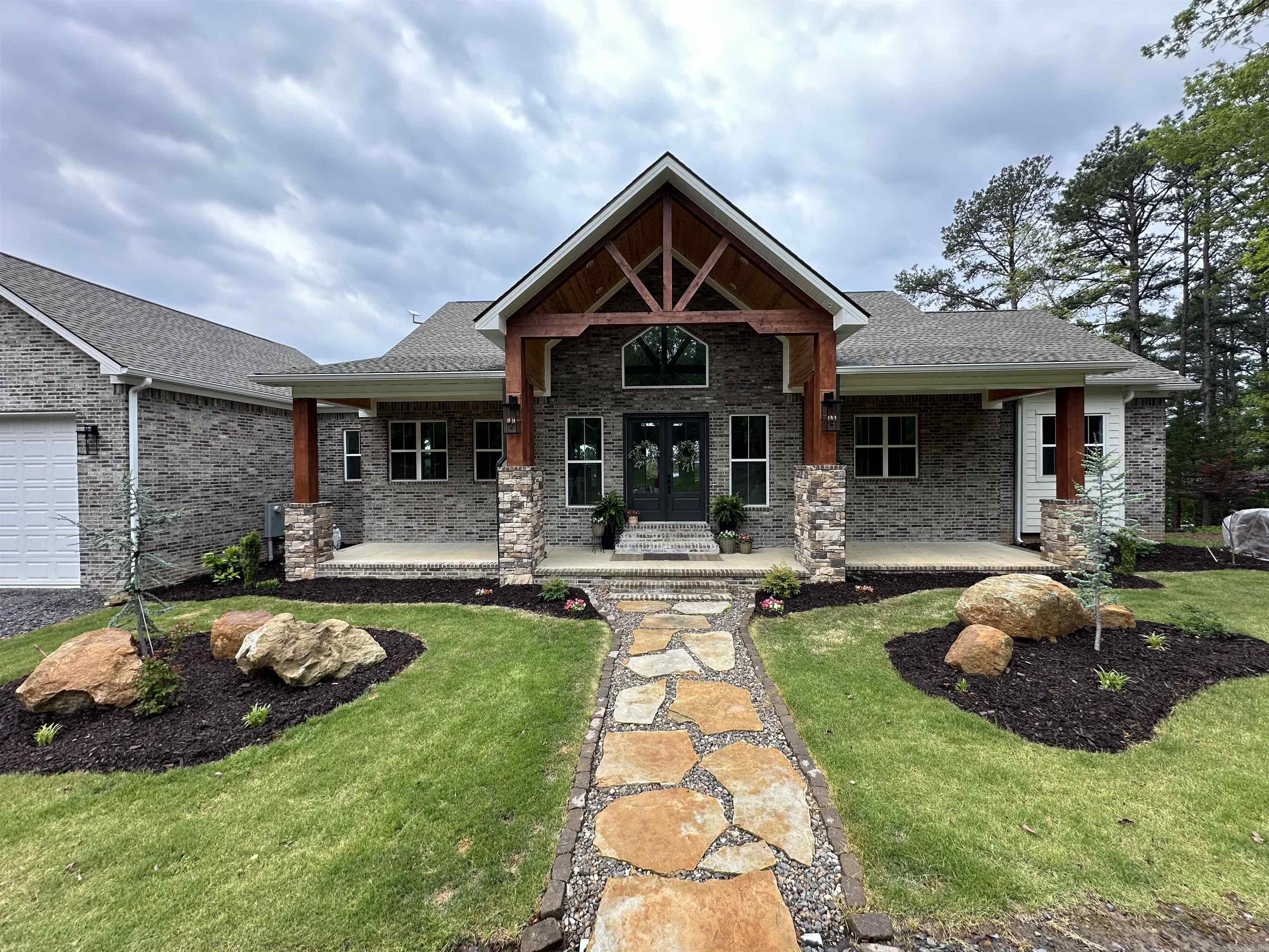 HOLIDAY PRICE IMPROVEMENT! Positioned in the heart of the prestigious Tannenbaum Resort on GREERS FERRY LAKE. Discover unparalleled lakefront luxury with this stunning 4,877 sq. ft. home on 1 acre, featuring 230’ of pristine water frontage. Perfectly designed for both relaxation and entertaining, this property offers breathtaking lake views, direct water access, & front-row seats to the 4th of July fireworks at Sandy Beach. Inside, you’ll find 5 spacious bedrooms, 4 baths, and 2 fireplaces—one of which is a grand stone wood-burning centerpiece in the vaulted living room. The gourmet luxury kitchen is a chef’s dream, boasting smart appliances and high-end finishes. Retreat to the oversized master suite with a spa-like bath & private deck is ideal, while the 2 living areas storm cellar & 2 laundry rooms add convenience & comfort. Step outside to expansive decks overlooking the lake, perfect for soaking in stunning sunsets. The oversized garage provides ample storage for your lake toys, & with a private airport strip, boat ramp, & the scenic Tannenbaum Golf Course just minutes away, this home is an outdoor enthusiast’s paradise. Enjoy the best of lakefront living!