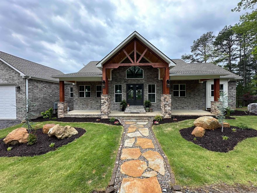 HOLIDAY PRICE IMPROVEMENT! Positioned in the heart of the prestigious Tannenbaum Resort on GREERS FERRY LAKE. Discover unparalleled lakefront luxury with this stunning 4,877 sq. ft. home on 1 acre, featuring 230’ of pristine water frontage. Perfectly designed for both relaxation and entertaining, this property offers breathtaking lake views, direct water access, & front-row seats to the 4th of July fireworks at Sandy Beach. Inside, you’ll find 5 spacious bedrooms, 4 baths, and 2 fireplaces—one of which is a grand stone wood-burning centerpiece in the vaulted living room. The gourmet luxury kitchen is a chef’s dream, boasting smart appliances and high-end finishes. Retreat to the oversized master suite with a spa-like bath & private deck is ideal, while the 2 living areas storm cellar & 2 laundry rooms add convenience & comfort. Step outside to expansive decks overlooking the lake, perfect for soaking in stunning sunsets. The oversized garage provides ample storage for your lake toys, & with a private airport strip, boat ramp, & the scenic Tannenbaum Golf Course just minutes away, this home is an outdoor enthusiast’s paradise. Enjoy the best of lakefront living!