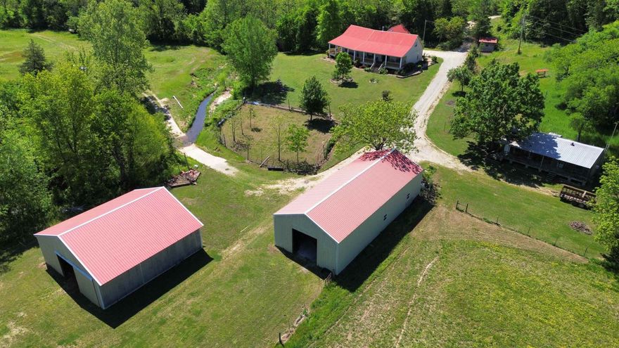 This is a prime 220 +/- acre hunting and recreational ranch with a true self-sufficient homestead, featuring a spring creek–irrigated garden that is surrounded by a fruit orchard of apples, peaches, blackberries, and muscadines. Approximately 5,000 feet of South Indian Creek runs through the middle of the property.  The home features 4 bedrooms—3 on the main level and 1 upstairs as a bonus room. There’s a large country kitchen and a great room centered around a massive stone, wood-burning fireplace. There is also a guest cabin, located within walking distance of the main house, that comfortably sleeps six. One of the best features of the home is the wrap-around front porch overlooking the creeks and garden, where you can often see wildlife right from your seat. This is truly a turkey hunter’s paradise. There are two large metal buildings—one is a shop with a big electric overhead door, and the other has 4 horse stalls with overhead hay storage.  The property includes numerous small food plots and about 60 acres of creek bottoms that can be used for hay or larger food plots. With 2 year-round creeks and 2 year-round springs, there’s all the water you could ask for— only $950,000.