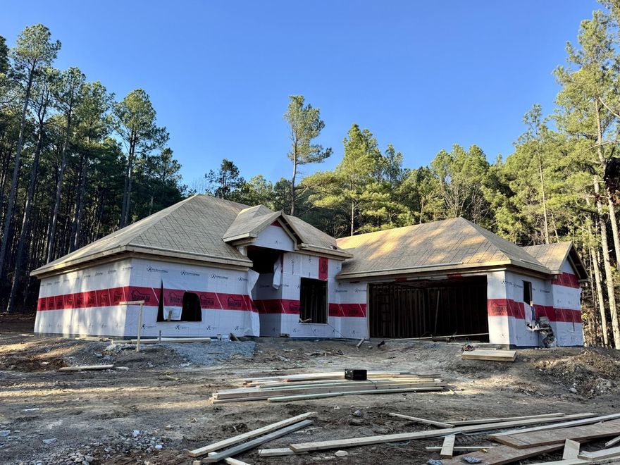 Enjoy comfort and class in this thoughtfully crafted new construction home, scheduled for completion by the end of June 2026, nestled on a quiet street in Hot Springs Village. Offering 1,865 sq ft of well-designed living space, this residence features 3 bedrooms and 2.5 bathrooms with an elegant open-concept layout ideal for both entertaining and everyday comfort. Highlights include a formal dining room, granite countertops, a gas fireplace that anchors the living space, and modern finishes throughout. Relax on the covered back porch and the convenience of a 2-car garage. The builder will allow the buyer to make select design and finish selections, providing a rare opportunity to personalize this home before completion. First-time Village property owners are subject to a $2,000 POA buy-in fee.