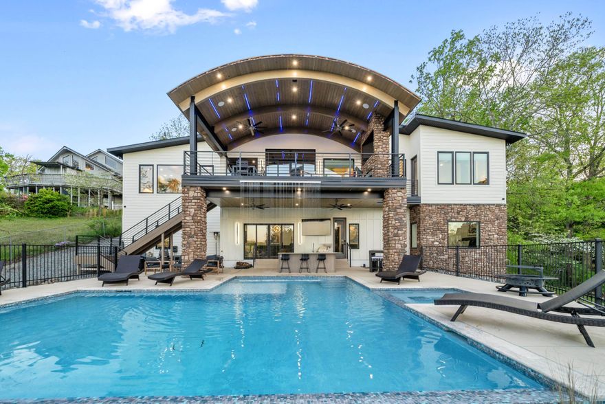 Welcome to an unparalleled masterpiece on the shores of Lake Hamilton—one of the most sought-after destinations in Hot Springs, Arkansas. This remarkable luxury lake home is not only one of the top-performing nightly rental properties in the area but also an ideal retreat for weekend getaways or a prestigious primary residence. Designed to impress the most discerning buyers, this sophisticated “Smart Home” seamlessly blends high-end appointments with cutting-edge technology, setting a new standard for luxury living. As you open the commanding front doors, you’re immediately captivated by sweeping lake views framed by a stunning custom barrel ceiling—a true testament to the builder’s exceptional craftsmanship. Every inch of this home is meticulously designed to offer an opulent yet welcoming atmosphere, perfect for both relaxation and entertainment. The heart of this home is its incredible kitchen, equipped withDekton countertops that are as durable as they are beautiful, Rift-sawn red oak cabinets with a sleek, modern aesthetic, Premium German steel faucets, and A state-of-the-art Miele built-in coffee maker, perfect for the ultimate morning indulgence.