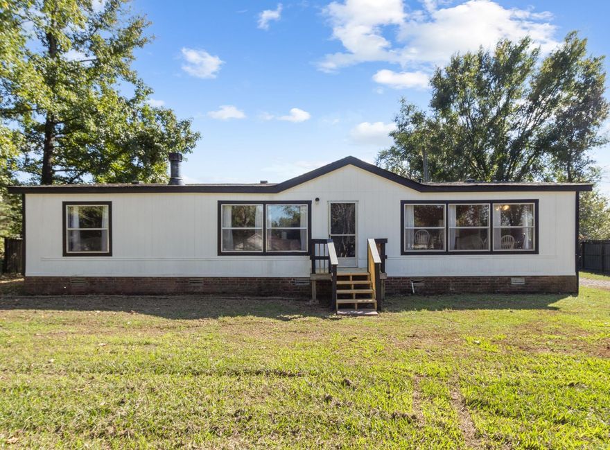 3 bedroom, 2 bath very spacious mobile on permanent foundation sitting on half acre with storm shelter in back yard.  Sits back from the road for more privacy and has a flat big front yard for kids to play.  Backyard has storm shelter for your peace of mind from intense weather.  2 bedrooms, both bathrooms and hallway has new flooring with extra flooring in boxes for you to change the existing original flooring, no carpet in any of the rooms. Living room has wood burning fireplace and plenty of room for your furniture. Large island in the kitchen with lots of windows for the natural lighting.  Has big laundry room with access to outside.  Master bath has large garden tub for your relaxation.  Home is being sold as is with negotialble third party repairs.  Square footage is approx, please measure.