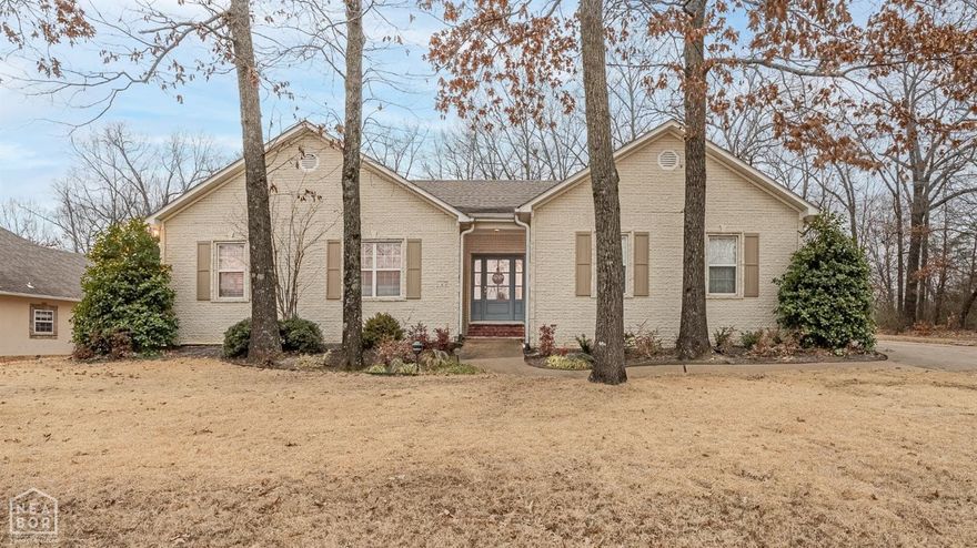 This adorable home has a cozy, traditional cottage vibe and is right in the center of Jonesboro, making it super handy for shopping, schools, and medical stuff. It's been given some recent upgrades including new appliances, carpet, and fresh paint. As soon as you step inside, you're welcomed by a lovely foyer with a beautiful wooden ceiling. The hardwood floors lead you into the dining room with beautiful built-in shelves and a living room with French doors to the patio. There's even a second living space with a fireplace next to the dining area, perfect for relaxing with a good book. The kitchen is offers stainless steel appliances, charming kitchen window above sink, breakfast bar, and breakfast area. The house has a smart design, with two guest rooms sharing a bathroom and a separate 1/2 bath for guests. The primary bedroom is spacious, bright, and has a big closet. The primary bathroom has been completely remodeled. There is plumbing under the settee in the bathroom for a soaking tub to be installed if desired. Outside, the backyard has a cool park feel with big trees, a patio, and a cross bar wooden fence. The house is at the end of a quiet road, and there's a garage with spac
