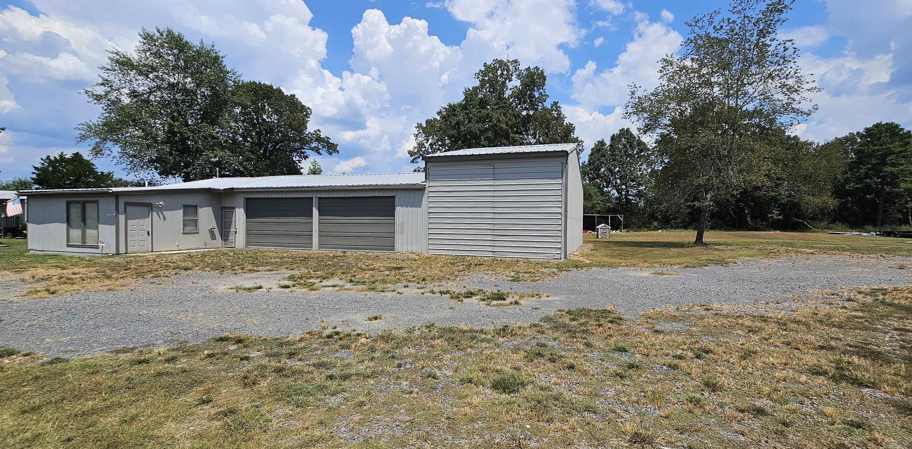 In the heart of Greers Ferry and 2 miles to Shiloh Marina, a 3,038 square foot shop with plenty of room for lake toys, equipment, or whatever you need it for. Unrestricted. Have a group of friends that come to the lake every weekend? Make it your weekend retreat with room for everyone. The shop has a concrete floor, metal roof, metal siding. Front area of shop has its own entrance and could be used as an office or studio apartment. Has bathroom, closet, and in main room, a countertop area. Shop is insulated, has a walk-thru door, 2 roll-up overhead doors (8' x 13'), and a larger swing-open door (12' x 18'). Has window unit for air and gas furnace for heat. Lean-to located at rear of property. Taxes TBD.