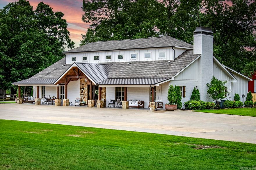 An outdoorsy dream 2 house estate tucked away just outside of West Little Rock. 4 bedroom, 3.5 bathroom beautifully designed barndominium on 13 acres with matching modern guest home. The main property features both a master suite and guest suite on the first level, open living space, formal dining, office/bonus room, creative flow space and oodles of smart storage. Upstairs two generously sized bedrooms both with walk-in closets share a third full bathroom. Front acreage is cleared and fenced for hobby farming or equestrian use, great shade trees throughout, and further past the homes lies a stocked pond with lighted pavilion island which make summer evenings dreamy and full of fun! The 1800 sq. ft. shop with 25 ft. bays can house all your favorite outdoor equipment. Guest home has living area, master suite, full service kitchen, and upstairs loft which can fit 3 twin beds! Attention given to all the details make this a diamond listing, truly one of a kind. Received multiple offers when sold previously. Agents see remarks.