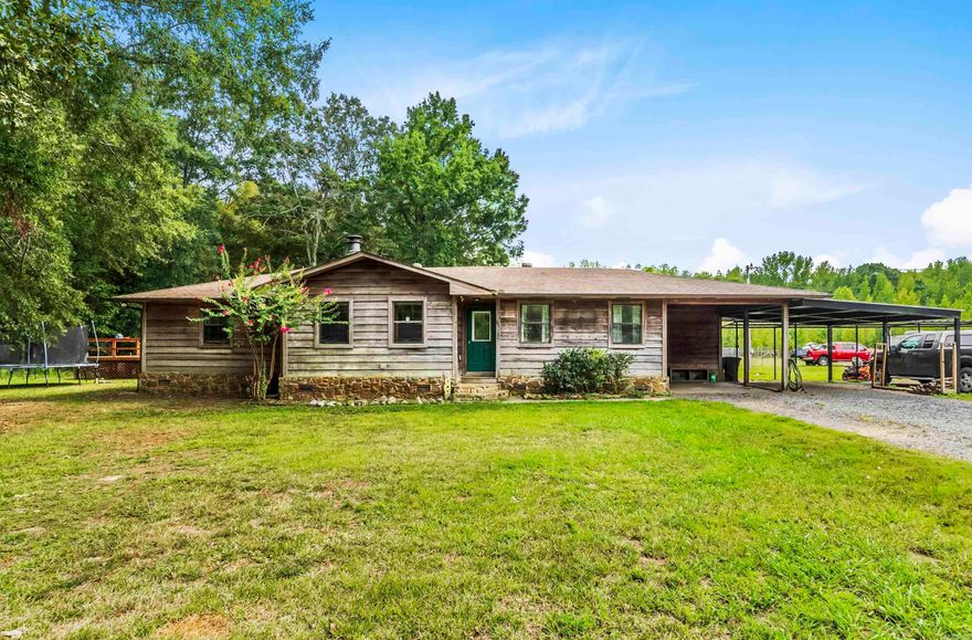 Enjoy the benefits of living in the country and living only a few minutes away from the city. This ranch style home has had many updates made and gives you all the creature comforts you would expect. There is a large deck with electricity, lights and a cooking area. Also covered seating area right outside the master bedroom. Also there is a sunroom. There is a new area that is attached to the main house by a covered walkway that has two bedrooms, open kitchen, laundry, and a handicap accessible bath. Also the property has 10 acres +or -. the land is pasture and wooded areas. It is fenced and cross fence.  A duck pond, 32x36 barn. Plus a 20x20 shop area with electric and vented with 1200 sq. ft. of storage. A 14x32 climatic controlled shed/shop with AC and lights. A 1 x32 lean to. The appliances are top of the line and convey with an acceptable offer.