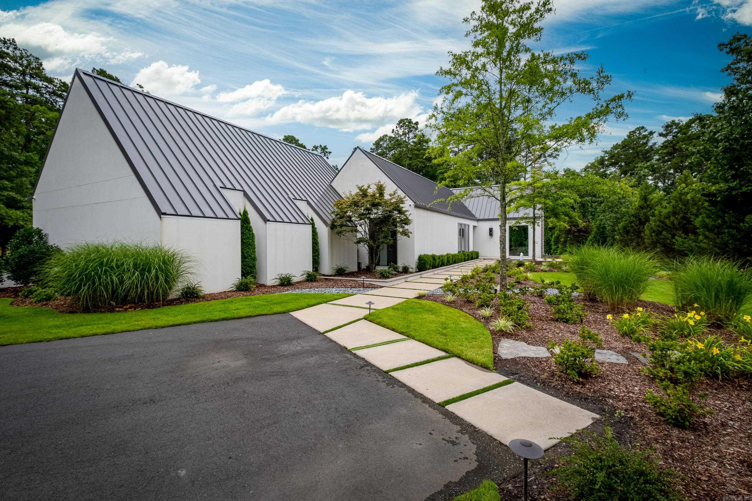 Welcome to this stunning contemporary one-level home located on the prestigious Chenal Country Club Golf Course. With its breathtaking views overlooking the picturesque 17th hole, this property offers the epitome of luxury living. The outdoor oasis features a saltwater pool, perfect for a refreshing swim, & a relaxing hot tub. As you step inside, you'll be greeted by a beautifully designed courtyard creating a serene space for outdoor entertaining. The interior boasts 10-foot glass windows throughout, allowing for an abundance of natural light and showcasing the magnificent views of the golf course. This is a true smart home w a Control 4 automation system, offering seamless control over lighting, temperature, and entertainment. The spacious floor plan encompasses four bedrooms and four & a half bathrooms, providing ample space for family and guests. The meticulously appointed kitchen features top-of-the-line appliances, making it a dream for any chef or culinary enthusiast. This gated neighborhood offers privacy & exclusivity. Immerse yourself in luxury & experience the epitome of contemporary living in this remarkable home that seamlessly blends style, elegance, & coolness!!