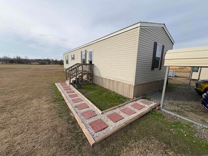 Look no further for the finest in country living on 1.81 beautiful acres, where space, privacy, and modern comfort come together. This 2022 single-owner Cappaert manufactured home (Big Foot Model) has been thoughtfully maintained and offers a wonderful opportunity to enjoy peaceful rural living with the confidence of a newer home.  The property features its own carport and a separate storage building, providing ample space for vehicles, tools, and outdoor equipment. With nearly two acres of land, there is plenty of room to relax, garden, entertain, or simply enjoy the quiet surroundings and open skies.  Whether you’re looking for a full-time residence, a country retreat, or an investment opportunity, this property delivers the perfect balance of comfort, functionality, and serene country charm—all just waiting to be called home!