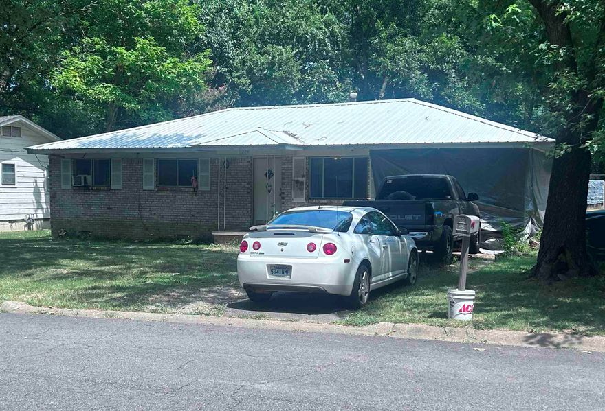 Discover this cute and classic home situated on a peaceful, tree-lined street. With a spacious yard perfect for outdoor activities, this property offers a blend of appeal and functionality. Perfectly priced for a first-time homebuyer or investor! Inside, the kitchen provides plenty of cabinet space. The home also features a laundry room and carport, adding to its practicality. This 2-bedroom, 1-bath home could easily be converted to a 3-bedroom. Recent updates, including a metal roof and a newer water heater, ensure this home is both comfortable and low-maintenance. This affordable gem is conveniently located close to shopping, downtown, schools and Arkansas Tech University. With a little TLC, this could be a beautiful little house!