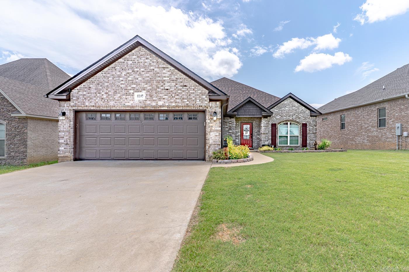 Welcome to Market 4145 Bobcat Meadow Lane of the Bobcat Meadows Subdivision in Jonesboro, Arkansas within the Nettleton School District. Situated on a beautifully manicured & landscaped .18 +/- acre lot w/ wood privacy fence is a 2022 built home wrapped in brick w/ shaker vinyl accent, topped w/ 2024 architectural shingles, and accented by shutters & gutters, covered front & back porch, and 2 car garage w/ storage. The interior features 1,928 sf of well laid out living space that contains an open concept living/kitchen/dining area. The eat-in kitchen hosts bar seating, stainless steel appliances, white cabinetry, granite countertops, subway tile, and pantry. The Master wing holds a generous sized bedroom w/ walk-in closet, 2nd closet, and en-suite w/ dual vanity, garden tub, and walk-in tiled shower. There are 2 spare bedrooms and a spare bathroom w/ shower/tub combo. Seller improvements include roof, gutters, drainage system in 2024, front & back landscaping, paint, shutters, fixtures, and more. Conveniently located near ASU, NEA Baptist Hospital, and retail & dining establishments. Sellers relocating to a new market. Call today to schedule your tour and make this house your home.
