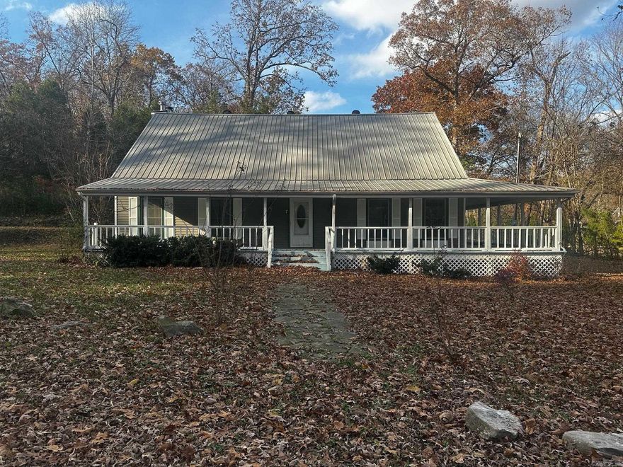 Imagine the charm of farmhouse living on 2.07 peaceful acres, just minutes from the heart of Downtown Rogers. With vaulted ceilings, a wraparound porch, and an open layout ideal for hosting and gathering, this home offers the perfect foundation to create the retreat you’ve always envisioned. Featuring four bedrooms and three baths in a generous design, plus custom cabinetry and large living spaces, it’s ready to be adorned according to your taste and lifestyle. Whether you’re planning your dream home, an Airbnb-style getaway, or a private country escape, the potential is here. Located just 4 miles from downtown, ½ mile from Monte Ne Chicken, and near lake access and boat ramp. Come walk the property and start imagining what this space can become. (See Agent Remarks)