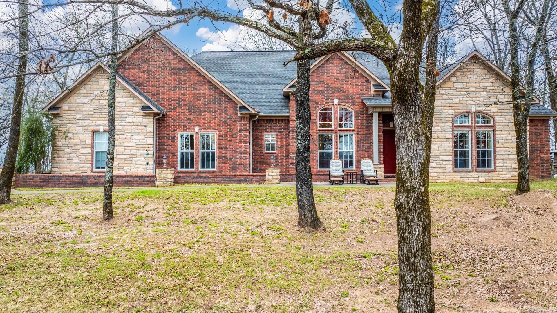 When was the last time you saw a house that can withstand an F5 tornado?! Behind the security gate you'll find a private drive leading you up the hill to one of Conway's best kept secrets. 3000sqft Main house, 1000sqft shop apartment, and 1400 2nd house. ALL exterior walls and ceiling are made of reinforced concrete. Windows are reinforced. Entry doors could double as bank vault doors. Not to mention the hidden safe room. All cabinetry is custom. House is in immaculate condition. Ceilings are all 10 ft, formal dining is 14 ft. Wood flooring in living room & formal dining room, carpet in bedrooms & tile in wet areas. Home has generator, wood burning fireplace & top appliances. Electrolux microwave, gas stovetop, dishwasher, double ovens & trash compactor. Massive 60x30' shop with 20x30 'apartment, both are heated & cooled. The second house on the property is 3bed 2bath and over 1500sqft and basically new construction. Great for family that you want to keep close or can be used for income producing. There is also an 8x20' underground bunker (not pictured). All building have their own heating/cooling systems as well as their own septic systems. All of this on over 20 acres.