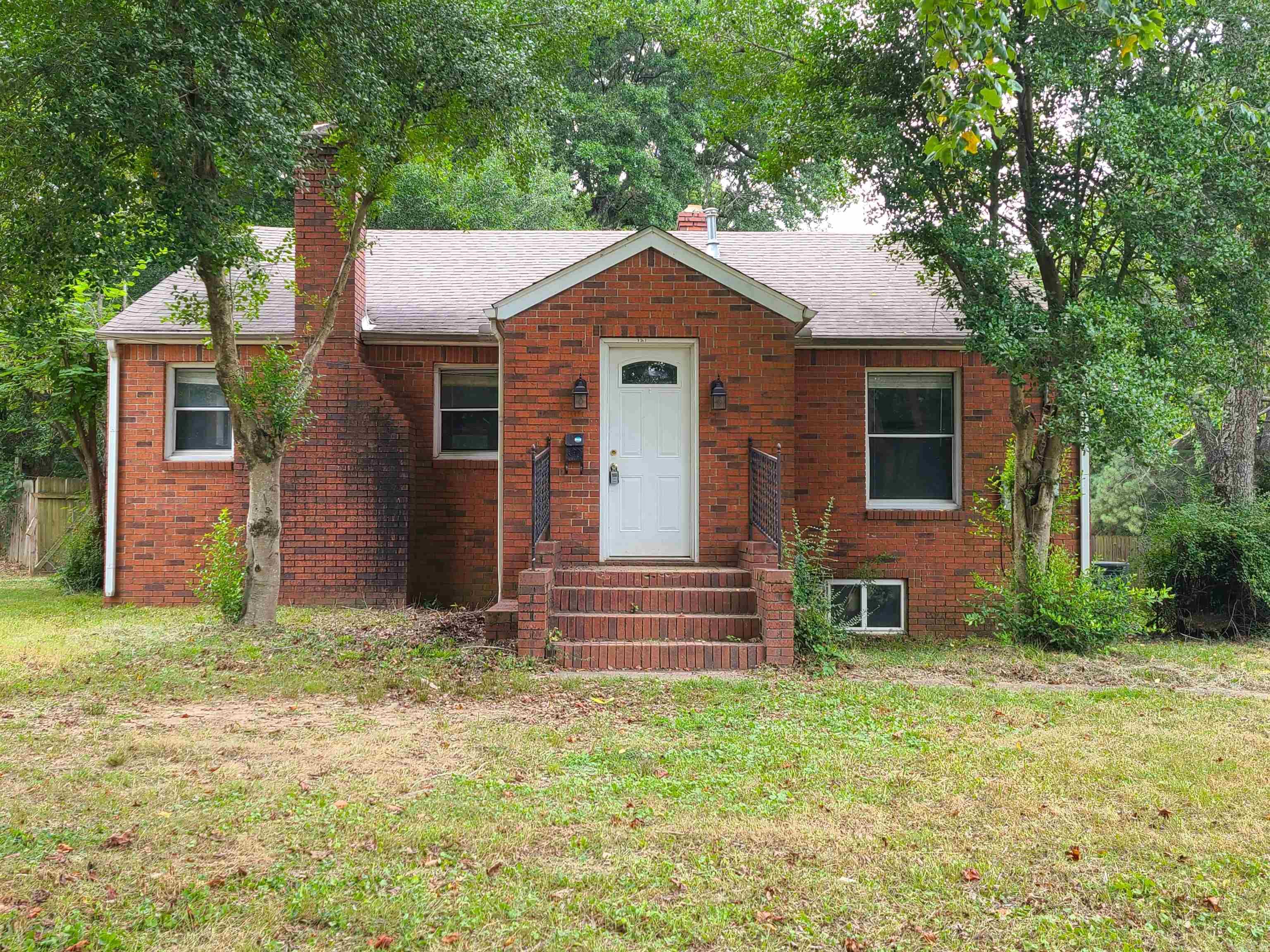 This adorable 2 bedroom, 1 bath brick home has 1,069 sq ft of primary living space and an additional 348 sq ft of space in the basement. The basement is currently unfinished, but could be turned into additional living space, game room, or great for storage! This home sits on almost an acre of land (0.92-acre, 102'x355' lot) and has the oldest pear tree I've ever seen! (no longer bears fruit) This property has an entry area w/coat closet, decorative fireplace (not functional for heating), open kitchen w/live edge breakfast bar, laundry closet for stackable washer/dryer, and a large 12'x14' deck off the back. The back yard is fully fenced and has a concrete pad that was most recently used for a basketball goal but would be a great location for a storage building. Give us a call to see this property for yourself! **appliances currently in the home are not in working order**