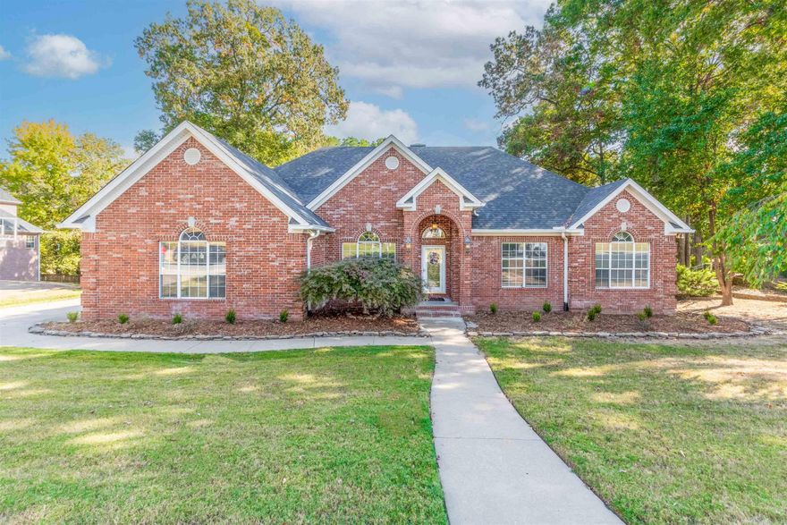 Located in Maumelle’s Osage Falls neighborhood, this stunning all-brick home offers 4 bedrooms, 3.5 baths, and a unique 1.5-story rear split design. Situated on a cul-de-sac, it features a split floor plan and beautifully crafted trim throughout. The spacious living room, complete with a wood-burning fireplace, opens to a “sunroom” bathed in natural light from a wall of windows—perfect for entertaining or relaxing. The eat-in kitchen has stainless steel appliances, granite countertops, a Miele dishwasher, and an under-mount sink with a Delta touchless faucet, while the separate dining room offers space for formal gatherings. The primary suite features a tray ceiling, en suite bath with a step-in tile and stone shower, dual vanities, dual closets, & a jetted tub. Two versatile rooms can serve as offices or craft spaces, with one convertible back to a larger laundry area. Downstairs, a living space with a full bath and separate outdoor entry is ideal for guests or short-term rentals. The backyard is an entertainer's dream with an in-ground pool that has a slide & new liner (2022) and expansive patios. Additional highlights include a side-load garage, gutters, and updated roof (2021).