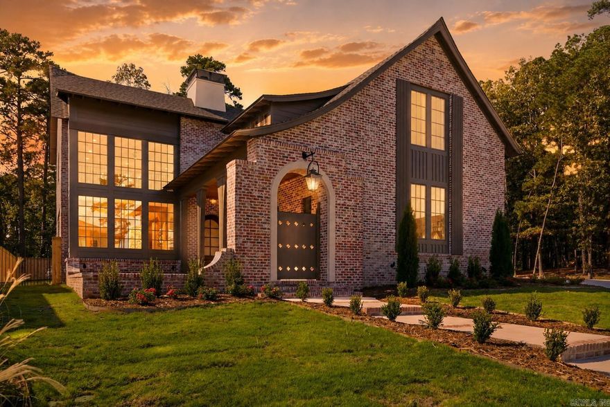 The Orle Residence is a French-inspired storybook manor reimagined for modern living. Crafted by HD Homes in collaboration with architect Salina Lambert, this architectural jewel rests within a gated and private Chenal community. Every detail has been meticulously curated, from custom wood and beam work with white oak beams to quartzite counters, honed Calacatta Vagli marble, and Bianca Rhino marble in the owner’s suite. Designer lighting from Visual Comfort illuminates artfully composed interiors, while the kitchen pairs bespoke wood finishes with Brizo Frank Lloyd Wright plumbing. The floor plan includes four bedrooms, four full baths, two half baths, a dedicated office, and a spacious media room, all flooded with natural light. Gas lanterns set a timeless tone, while the back porch extends entertaining with an outdoor kitchen and built-in heaters. Rare in both detail and refinement, this designer showcase masterpiece is truly worthy of Architectural Digest. *Virtual staging used
