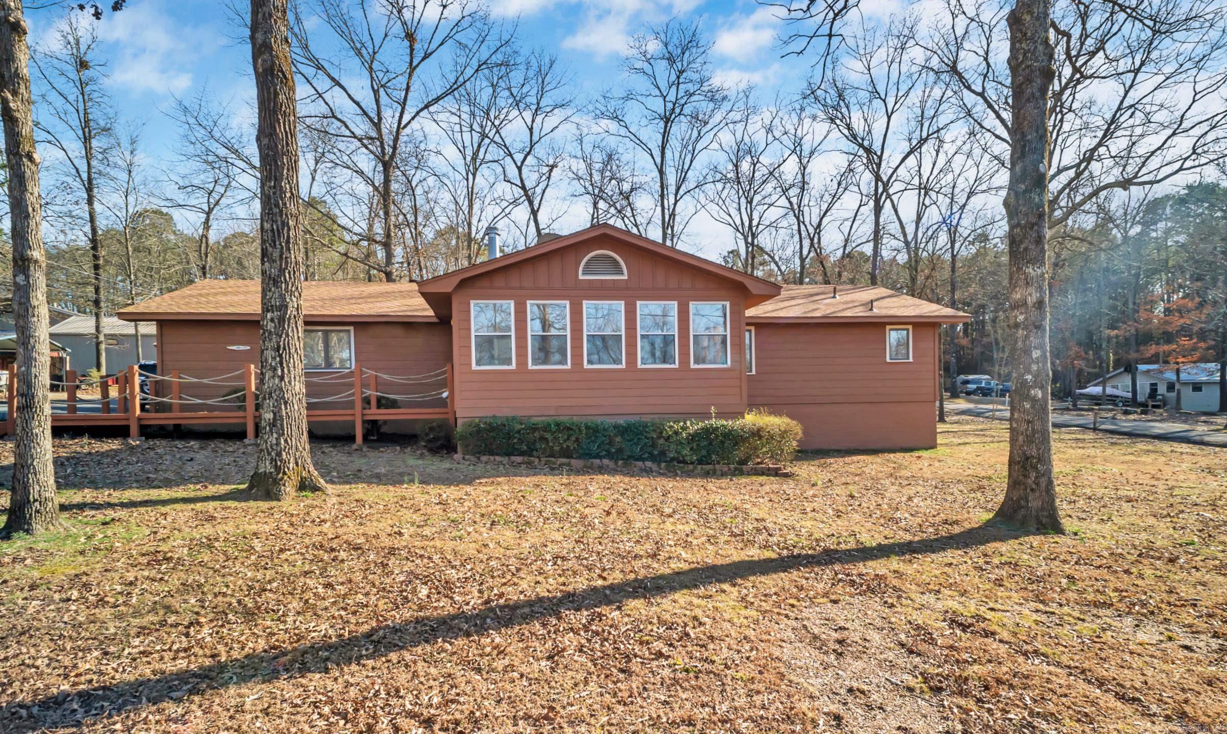 Charming 3-bedroom, 3-bathroom home in Greers Ferry is beautifully updated and situated on a spacious .72-acre corner lot. 1,880 sq ft of living space, each bedroom enjoys its own private bathroom, offering ample space and privacy for family and guests. Recent renovations include a brand-new HVAC system installed in 2024, ensuring year-round comfort. The roof, dishwasher, and screened back porch were all updated in 2023, while new flooring and fresh paint throughout the home add to its appeal. The front bathroom was remodeled in 2021, and the kitchen and primary bathroom have also received modern upgrades. A new chip & seal driveway was completed in 2018, providing convenient access around the house. Step inside to discover a heated and cooled enclosed front porch for year-round enjoyment, and an open-air back porch with vaulted ceilings perfect for relaxation. The large living room is ideal for gatherings, while the 2-car garage and additional shop building with electricity offer plenty of storage and workspace. Located just three streets away from the scenic Greers Ferry Lake!! CALL TODAY FOR SHOWINGS!!