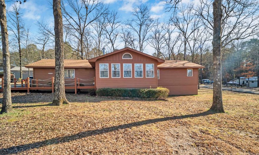 Charming 3-bedroom, 3-bathroom home in Greers Ferry is beautifully updated and situated on a spacious .72-acre corner lot. 1,880 sq ft of living space, each bedroom enjoys its own private bathroom, offering ample space and privacy for family and guests. Recent renovations include a brand-new HVAC system installed in 2024, ensuring year-round comfort. The roof, dishwasher, and screened back porch were all updated in 2023, while new flooring and fresh paint throughout the home add to its appeal. The front bathroom was remodeled in 2021, and the kitchen and primary bathroom have also received modern upgrades. A new chip & seal driveway was completed in 2018, providing convenient access around the house. Step inside to discover a heated and cooled enclosed front porch for year-round enjoyment, and an open-air back porch with vaulted ceilings perfect for relaxation. The large living room is ideal for gatherings, while the 2-car garage and additional shop building with electricity offer plenty of storage and workspace. Located just three streets away from the scenic Greers Ferry Lake!!  CALL TODAY FOR SHOWINGS!!