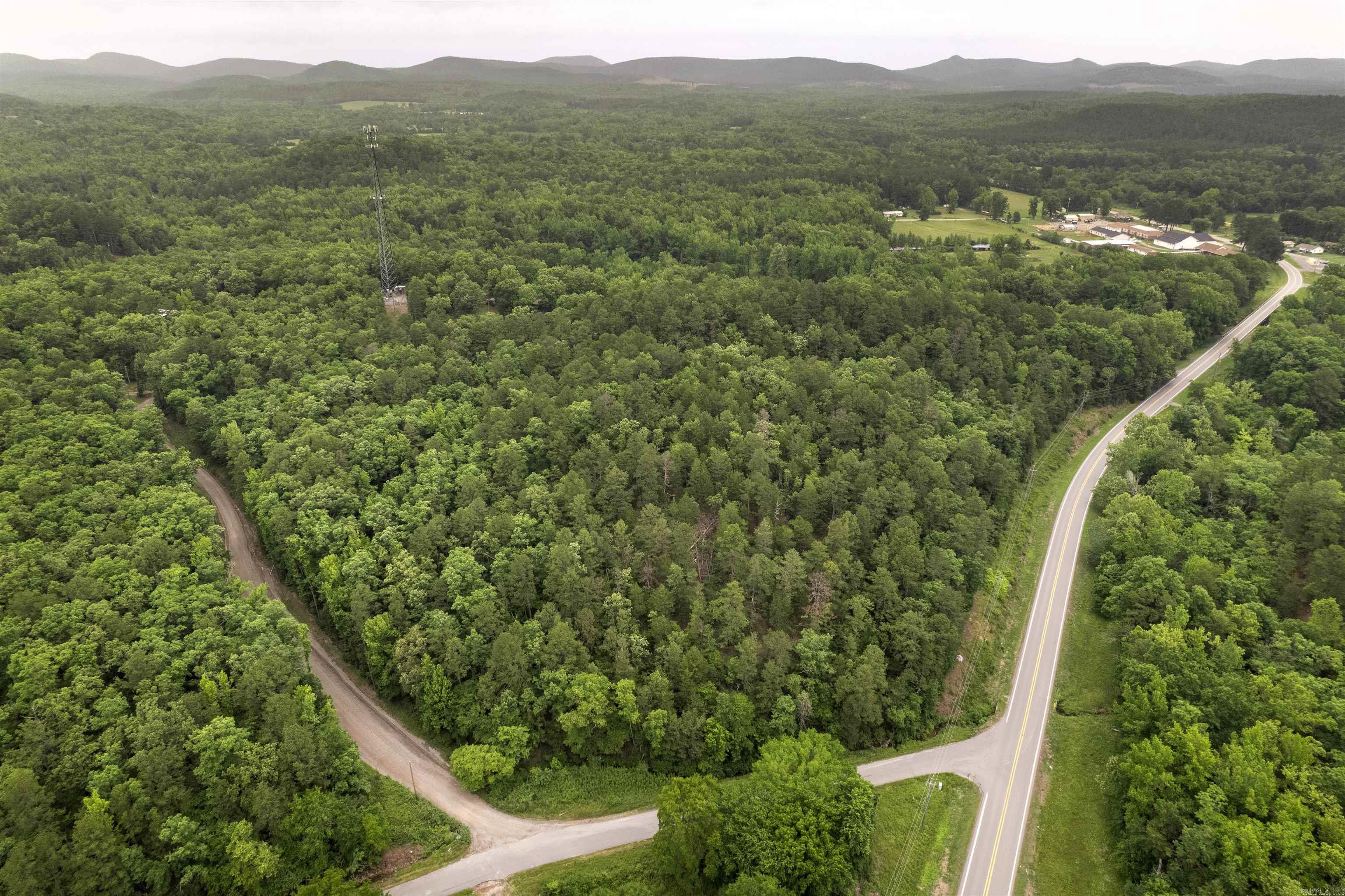 Beautiful scenic property +/-15 acres perfect for building your dream home. This property boasts building opportunities that have the potential to provide gorgeous views of Pinnacle Mtn or tuck yourself away in the trees. A quick and easy trip of about 25 minutes into the Chenal area of Little Rock for shopping, dining and entertainment make this an ideal location for someone who wants to be close to all that Little Rock has to offer without living in the city. Little Rock National Airport is a fast 50 minutes away for ease of travel. As a bonus this property is nicely situated near the Ouachita National Forest for the outdoor enthusiast in your family, with wonderful opportunities to hunt, hike trails, lakes nearby for boating and fishing and just being out in nature. Three of the four property lines are on road frontage, so you even get to chose where you would like your driveway to be located! Now that's what I call, "Having choices!" Come take a look for yourself at this beautiful property and let your imagine run wild! **Possible Owner Financing