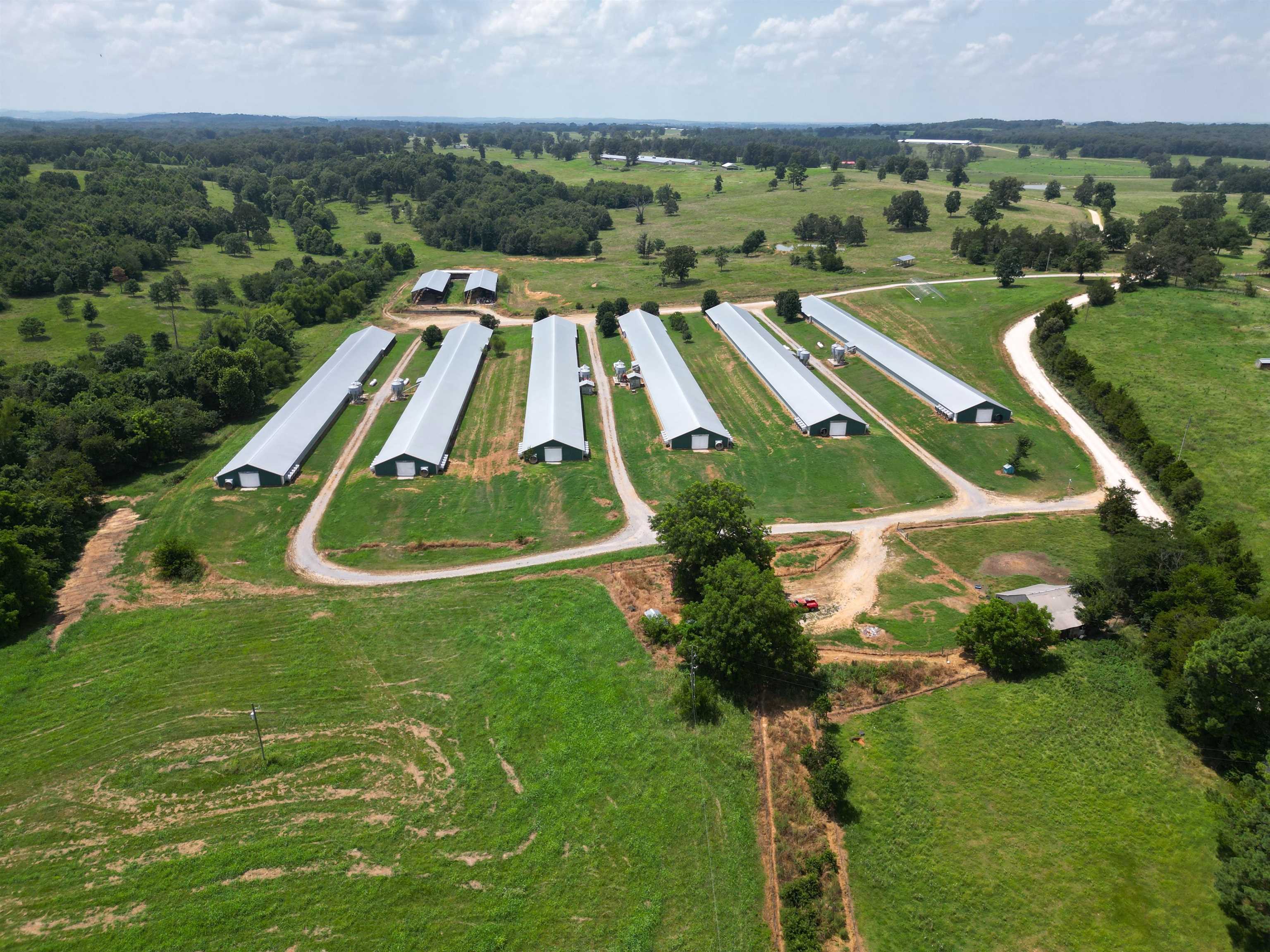 Beautiful Opportunity Available in North Arkansas! Lucrative, high income producing Poultry Farm sitting on 32 acres +/- , bordering a picturesque spring fed creek, has 6 broiler houses 43 x 450 ea, 2 stacking sheds 40 x 150 ea, a well house with new pump and 3 water tanks, city water, new compost facility, hay field AND a tiny house all fenced and cross fenced allowing for additional homesteading and animals. This farm boasts impressive technology including the AGRI Alert System. The houses are completely updated and equipped with a computerized control system that operates ventilation, climate, feeding and watering which can even be monitored remotely! Two generators will operate the facility in the event of power outage. Houses were built 2006 and fully updated 2020. Stack Sheds built 2017. PECO contract currently. Ask about financing!