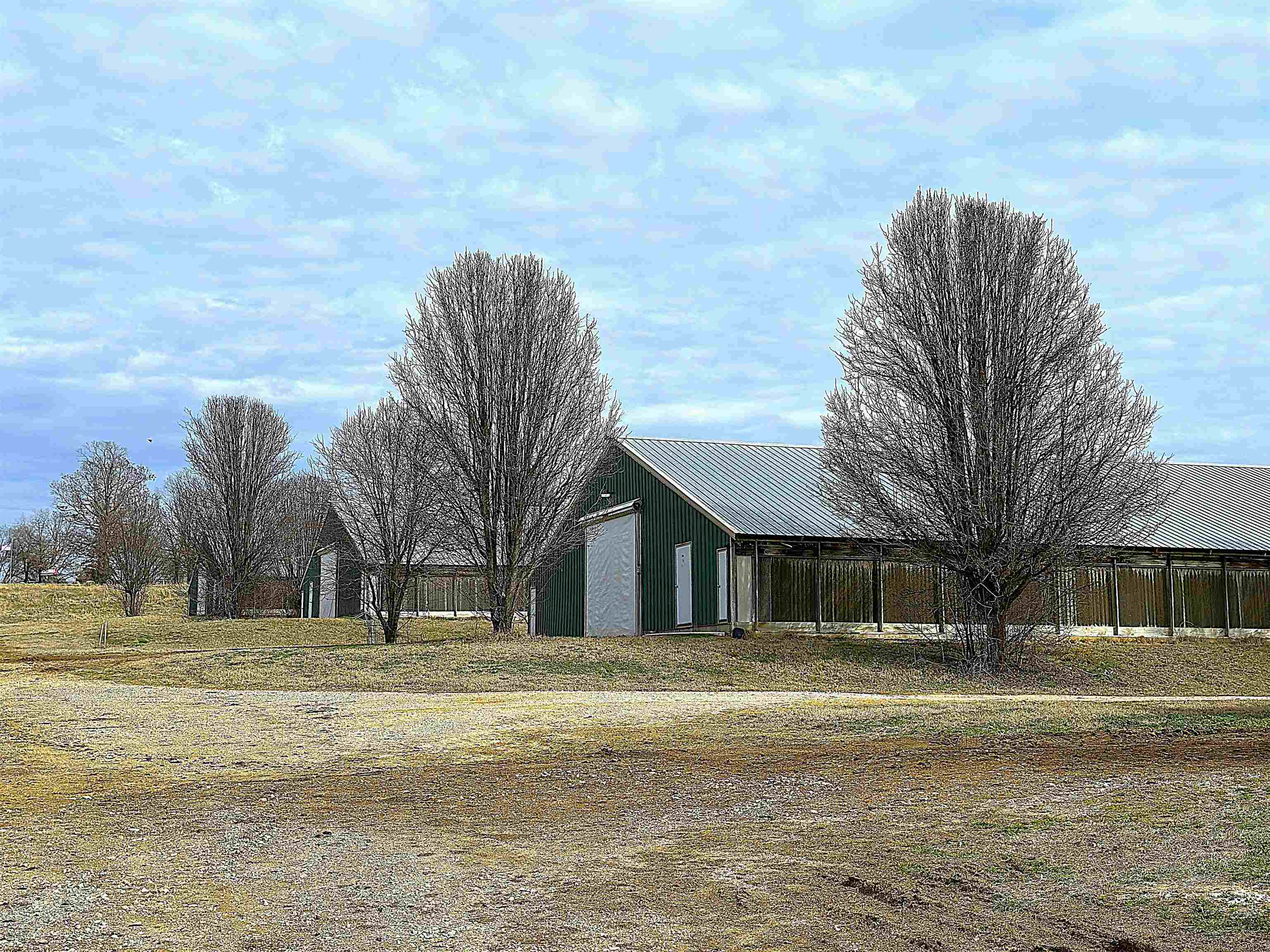 Beautiful Opportunity Available in North Arkansas! Lucrative, high income producing Poultry Farm sitting on 32 acres +/- , bordering a picturesque spring fed creek, has 6 broiler houses 43 x 450 ea, 2 stacking sheds 40 x 150 ea, a well house with new pump and 3 water tanks, city water, new compost facility, hay field AND a tiny house all fenced and cross fenced allowing for additional homesteading and animals. This farm boasts impressive technology including the AGRI Alert System. The houses are completely updated and equipped with a computerized control system that operates ventilation, climate, feeding and watering which can even be monitored remotely! Two generators will operate the facility in the event of power outage. Houses were built 2006 and fully updated 2020. Stack Sheds built 2017. PECO contract currently. Ask about financing!