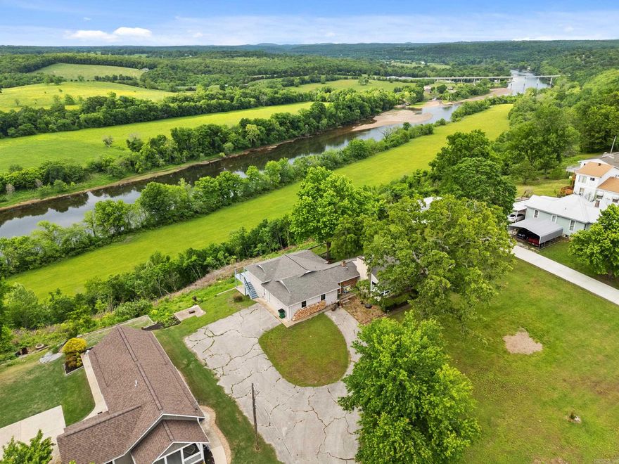 Mid-century modern overlooking the White River in Cotter with a distant view of the new Cotter Bridge. This one-of-a-kind property delivers an out-of-this-world setting—river in the foreground, rolling cattle pasture in the distance, and breathtaking sunsets over the river valley.Inside you’ll find original tongue-and-groove hardwood floors, an updated kitchen with granite countertops, and a layout that captures the views from nearly every angle. New shingles in 2026, small basement for storage, paved road frontage, and just up the street from river access. Very well kept and completely move-in ready.Watch eagles fly by, enjoy world-class trout fishing on the White River, and take advantage of being close to Big Spring Park. Nestled in the Ozarks, Cotter is known as the Trout Capital of the World—and this home puts you right in the heart of it.Views, views, views—river valley living at its finest. Properties like this don’t come along very often.