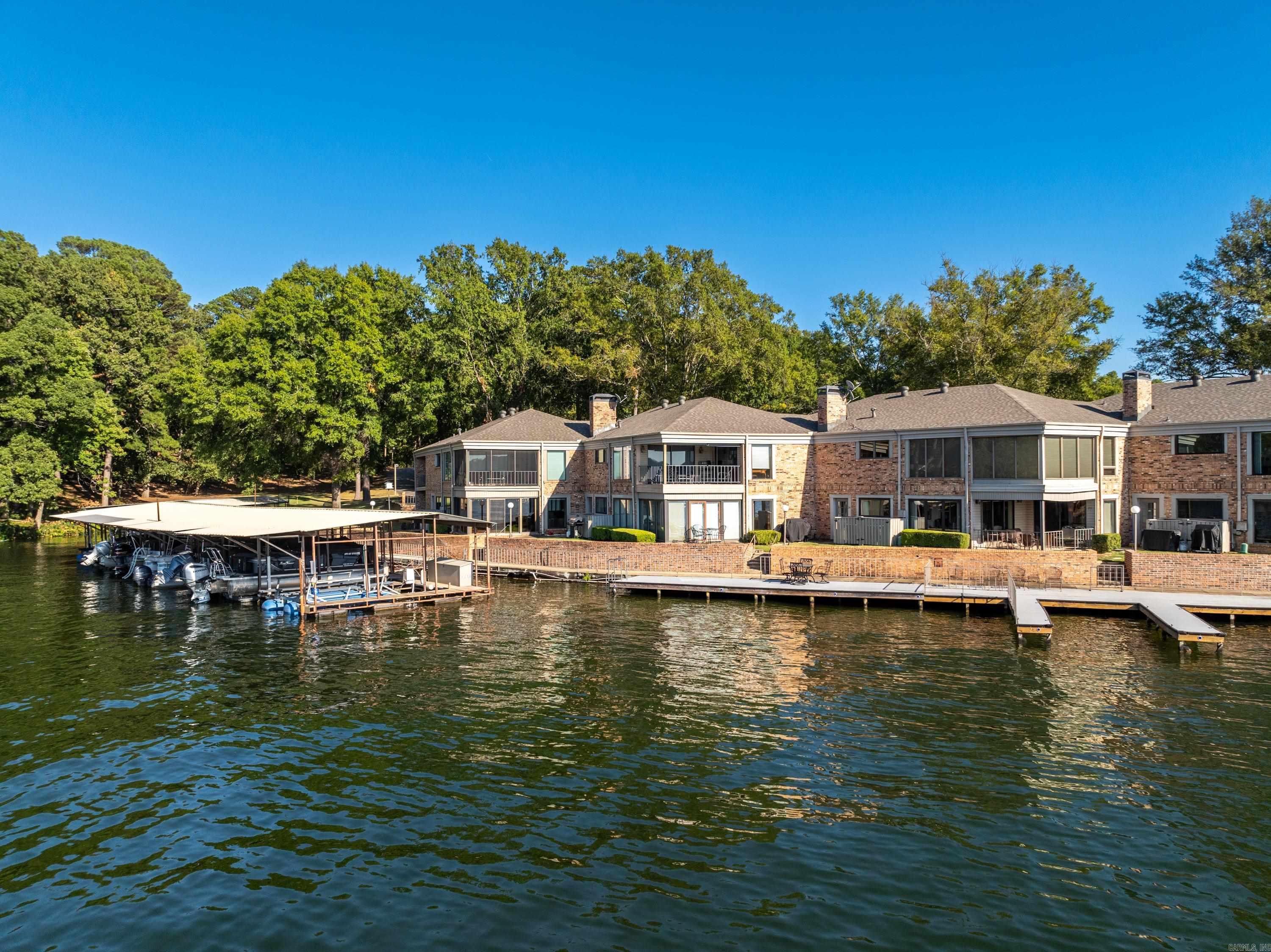 WELL APPOINTED CONDO RIGHT ON THE WATER in the GATED community of SCULLY POINT! Welcome to your weekend retreat on beautiful Lake Hamilton. Relax on the waters edge while enjoying the AMAZING VIEWS from this FURNISHED 3 bedroom 2 bath condo. BOAT SLIP WITH NEW LIFT INCLUDED. Watch the boats go by from the large patio or boardwalk in this 1,638 sq ft condo that includes refrigerator as well as a 1 year home warranty. Lots of floor-to-ceiling windows to maximize the views. Convenient location close to everything - minutes to Oaklawn Racing Casino Resort, downtown Hot Springs and Bath House Row as well as shopping & restaurants. This one is a must see!