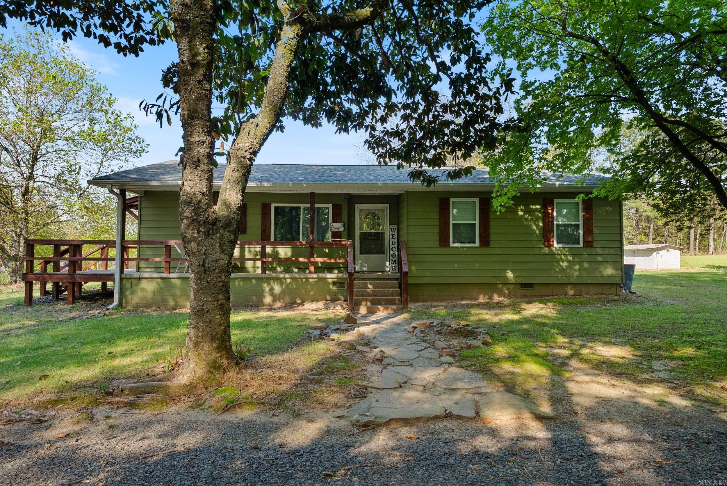 SITTING ON TOP OF PETIT JEAN MOUNTAIN talk about the PERFECT location. This property would be ideal for a vacation home or short term rental or even a permamant residence. Tons of updates including refinished original hardwood floors, new roof, new HVAC, new water heater, new paint, and also a completely remodeled bathroom with walk-in tiled shower. Step out of your kitchen or living room onto the newly built deck and enjoy the peaceful mountain air! All of this sitting on almost 2 acres with a barn. The addtional land is already cleared and ready for building. Schedule your private showing today