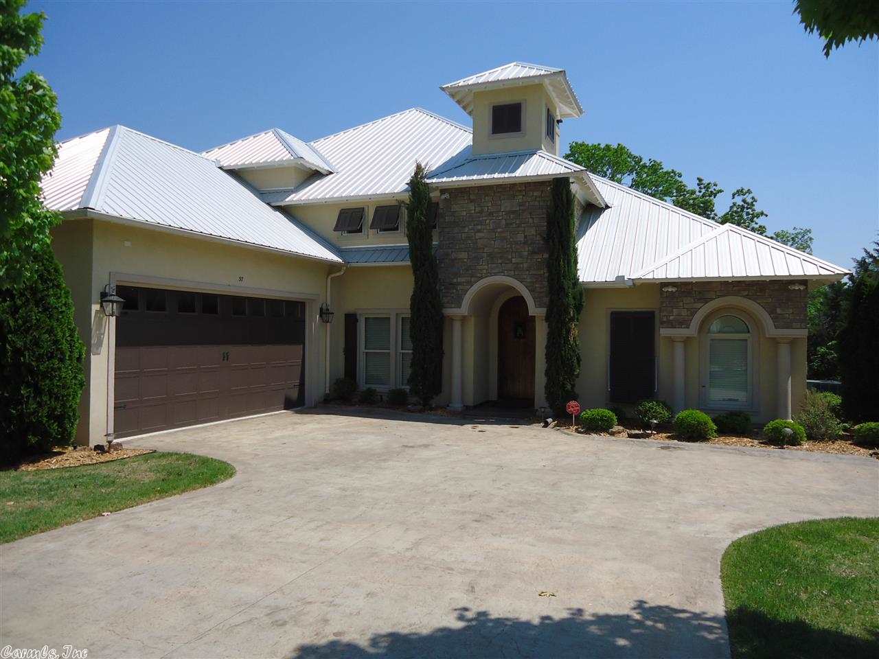 Beautiful gated lakefront subdivision. This home is lakefront with a view and lake access. Close to shopping, hospital, Dam Site Marina. Subdivision has a pool. What more could you ask for? Beautiful 2 story home with Master downstairs. Upstairs has 2 bedrooms, 1 bath, and living area for your guests. Rock wine cellar, security system, & 2 attic storage rooms. Sprinkler system, extensive landscaping & 2 story deck with lake view.