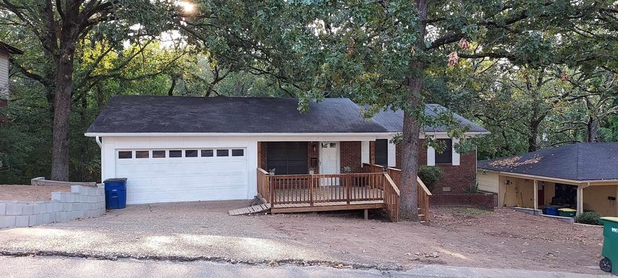New 2023 updates include flooring, paint, fixtures, insulation, french drains, and retaining walls. Kitchen and master bathroom remodel done within the past few years. The attached sunroom overlooks the huge deck and backyard. All in the heart of North Little Rock!! You won't find a more convenient location. Walk to the gym, pharmacy, restaurants, coffee shops, parks, shopping.