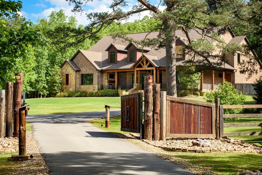 Experience refined lodge-style living in this exceptional custom home set on 5.05± private acres, masterfully built by Tim Hughes. Thoughtfully designed with craftsmanship at every turn, the interior features oversized solid wood doors, custom cabinetry throughout, and a dramatic stacked rock accent wall in the formal dining room. The open-concept living, dining, and kitchen spaces are ideal for entertaining, anchored by a chef’s kitchen with four KitchenAid Professional Series ovens, a gas range with griddle, and abundant storage. Specialty spaces include a library/office with cozy reading nook, a professional-grade theater room with a 200-inch screen and SVS sound system, a craft room with padded commercial flooring, and a fun bunk/sleepover room. Two laundry rooms, a dog washing station, and exceptional storage add everyday convenience. Outdoor living shines with a covered front porch featuring a fireplace, a spacious screened porch with outdoor kitchen, greenhouse, and ten raised garden beds. Additional highlights include a heated and cooled four-car garage and two whole-house generators—offering luxury, comfort, and peace of mind in a truly one-of-a-kind setting.