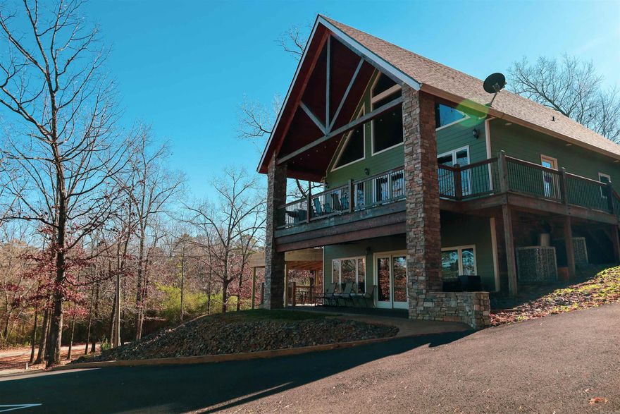 Lakefront/view condo w/boat slip to use when staying there! 2-Bed, 2-Bath, Approx 1,267 Sq Ft downstairs unit. Fully furnished w/stainless appliances, new adjustable base beds (2025), SMART TVs (2023), stacked washer & dryer, bar stools, couches, kitchen table, patio furniture, & more! Begin using & VRBOing this unit Day 1. Entering the home notice the open concept, the immaculate condition, the large stone fireplace, granite countertops, & more! Unit is VERY energy efficient! High Speed Fiber Internet is available & in place today. Upgrades such as under cabinet lighting, granite counter tops in kitchen & bathrooms as well as real hardwood floors & instant hot water too! The covered front porch boasts a custom concrete & stacked stone columns. This property also has a covered deck to the side w/ tongue and groove ceiling & more! This property is assigned Boat Slip 4 (Qty 1) & Parking Spots 4 Assigned (Qty 2) in the Bellawood Resort. Broker Owned Property. To retain use of the assigned boat slip you must also participate in renting out this unit as nightly rental “some” from April – Sep each year per Corp of Eng Regulations for Boat Slip Lease – See Agent Remarks & Assoc Docs.