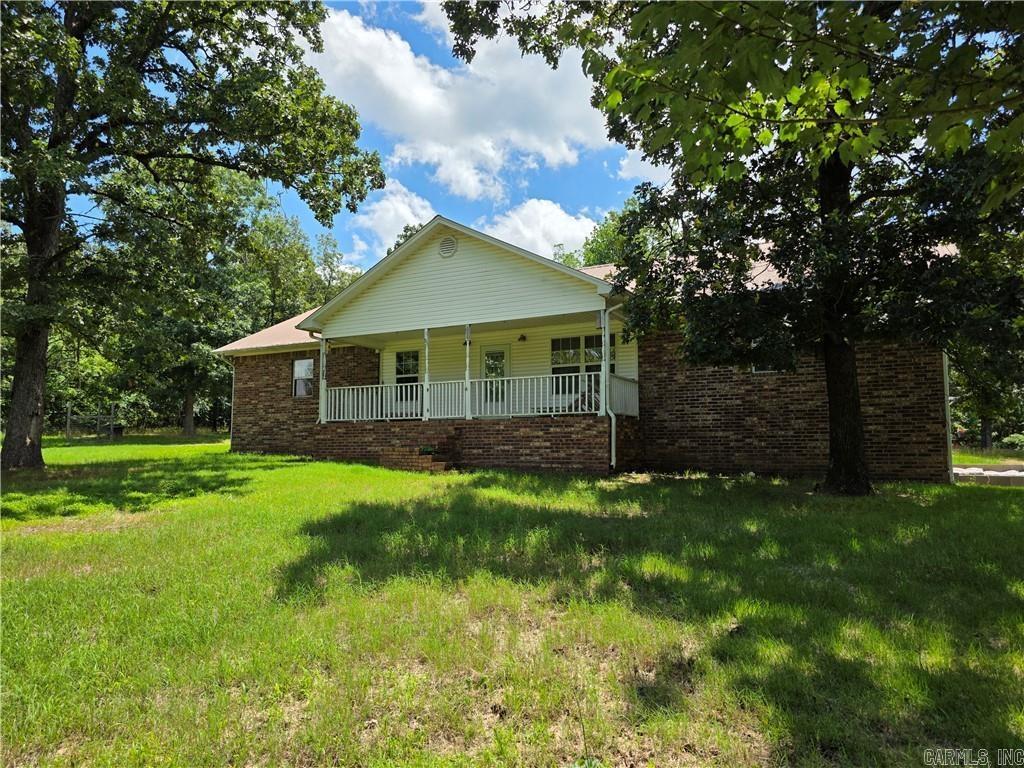 8 secluded acres featuring a brick home with 4 bedrooms and 3 bathrooms and a long lasting metal roof. Designed with a split floor plan and Jack and Jill bathroom for 2 of the bedrooms. The primary bath has a jetted tub/shower combo with double sinks. Ideal for hunting, gardening, homesteading, etc. The property includes a chicken coop and has approximately a 1-acre fenced area. There is a storage area with the detached carport, storage building, and storage shed. Located just minutes from Dover.