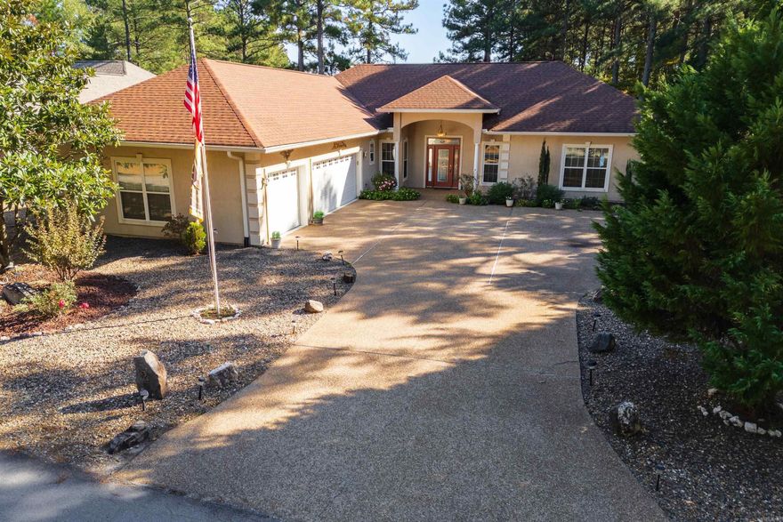 Granada Golf Course Gem - Built on a level lot, this 3 Bedroom, 2 bath home with office and Arkansas room sits directly on the Granada Golf Couse -- one of Hot Springs Village's most scenic and challenging courses! The spacious layout of this home features a central kitchen with lots of cabinetry/storage; split bedroom plan; vaulted ceilings in the main living area; a dedicated office with closet--ideal for remote work or a potential fourth bedroom; an Arkansas Room that provides for year-round relaxation; and an oversized 3-car garage that easily accommodates your cart, clubs and gear.  Enjoy sitting outside on the covered tiled patio watching golfers from the tee box to the green on this Par 4 hole. From front to back the exterior of this home is sure to please with professional landscaping and a peaceful water feature.  Hot Springs Village is a golfer's paradise, offering access to nine unique courses and top-tier practice facilities just minutes from your doorstep.  Whether you're a seasoned golfer or just starting out, Hot Springs Village offers a vibrant lifestyle with something for every skill level.  See Agent Remarks for more details.