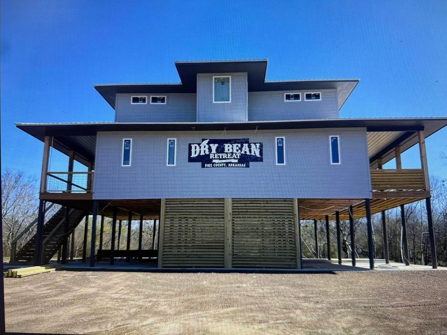 Arrowhead Island Subdivision, Little Missouri River front property, offers a custom built home aka: "Dry Bean" VRBO rental property with a 9.8/10 guest rating and current booking dates that can transfer to new owner.  The possibilities are endless with this river front property including: trout fishing, exploring, canoeing, or rafting, minutes from area amenities including: the Crater of Diamond State Park and Lake Greeson, this home is fully furnished and turn key ready.  This home offers a master suite and additional bedroom and full bath on the main floor, 2 additional bedrooms and 2 full baths upstairs.  Spacious living room with fireplace, kitchen with island bar and dining area, laundry closet with stackable washer/dryer and extra storage.  Large wrap around entertaining deck w/exceptional view of the river. If you are looking to relax and unwind or set out on an adventure, this river front property offers it all.  Contact our office for more details or to schedule a private tour.