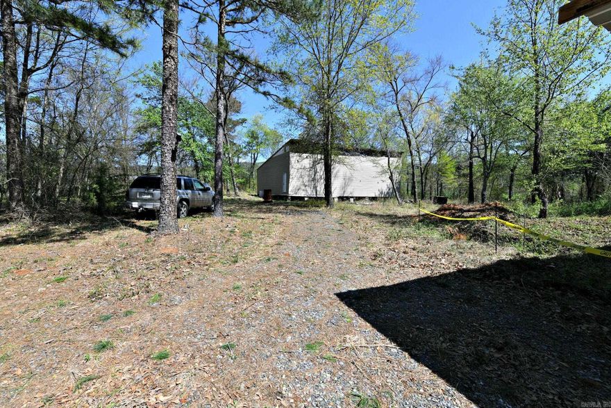 Discover the perfect blend of nature and potential with this beautiful 2-acre wooded property. Tucked away in a serene and private setting, this land comes equipped with underground electric and an on-site well, providing essential utilities for your future plans. The property also features an RV hook-up and a covered area, making it ideal for weekend getaways or temporary stays (please note: RV/Camper is not included in the sale). Additionally, there is an unfinished house shell on the property, offering a blank canvas full of potential to build your dream home, cabin, or getaway retreat. While the house currently has no improvements, the structure is ready for your creative vision and finishing touches. Whether you're looking for a peaceful escape or a place to start a custom build, this property offers a rare opportunity to create something truly special.