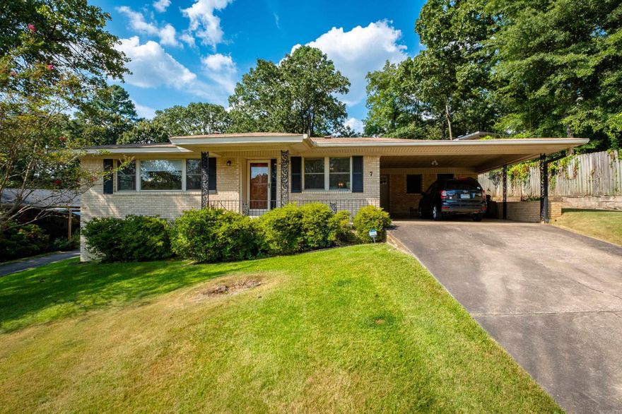 Located on a quiet cul-de-sac in Little Rock's Midtown neighborhood, this adorable mid-century Ranch has tons of updated features, including a spa-like primary bath. The expansive front living room and separate dining room are full of natural light and have newly refurnished hardwood floors. The eat-in kitchen is open to the den for more casual living & entertaining. Enjoy outdoor living on the back patio and fully-fenced, level backyard. Other updates include new windows throughout, new hot water heater and upgraded attic insulation. The home sits atop a slight hill with a long set-back from the street and has covered parking for two cars. A storage closet in the carport is a convenient spot to stow lawn supplies. Agents, please see showing remarks.