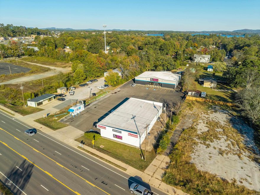 Back building offers over 7800 sq ft of open space. It is currently leased by Ready Set Skate.  35 parking spaces plus additional access around the perimeter. Shared driveway with business suite and ice machine at the front of the property (those businesses ARE included) at Hwy 7 South/Central Ave. Road expansion is complete in the area.