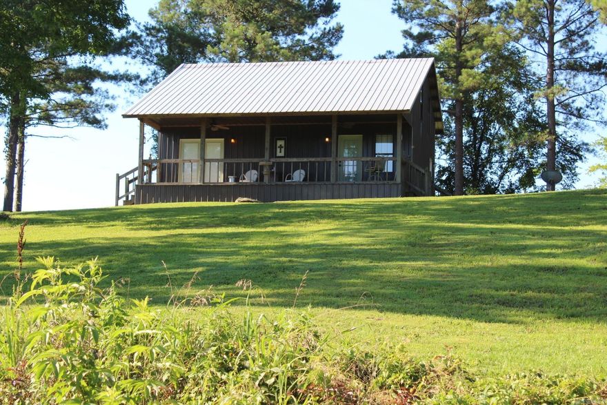 Cabin with access to Lake Greeson with approx. 1152 Sq. Ft. of living space.  Large kitchen/dining, living area.  2 bedroom and laundry area.  Covered 7 x 32 front porch with beautiful views.  ALL FURNITURE AND APPLIANCES CONVEY WITH CABIN.