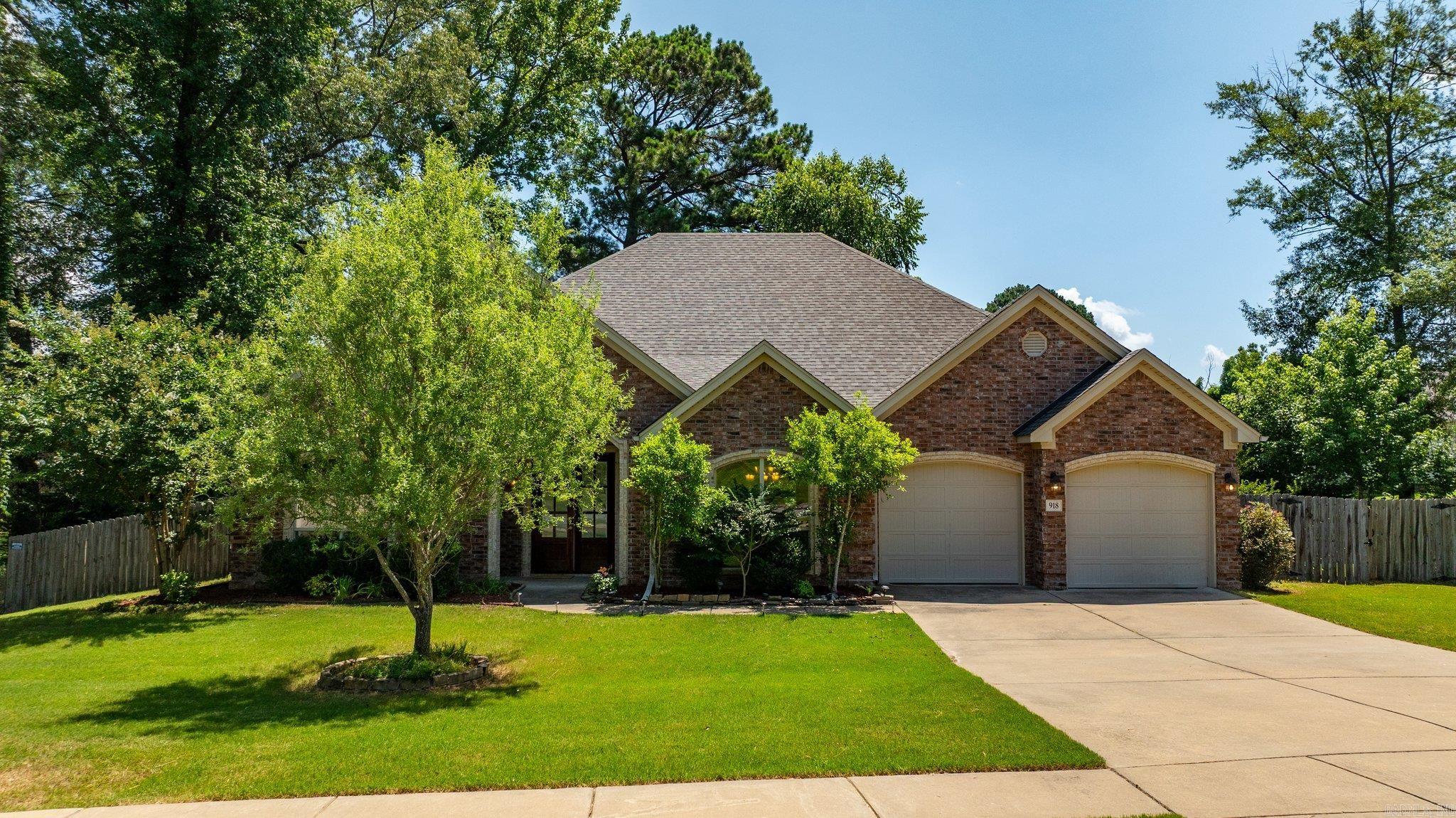 Welcome to this charming home nestled on a spacious 0.62-acre corner lot in Bryant! This prime location offers convenient access to schools, dining, shopping, and major highways. This delightful residence features a well-designed split floor plan, comprising 4 comfortable bedrooms and 2 full bathrooms. The living room features elegant hardwood flooring, a soaring ceiling that enhances the sense of space and the cozy fireplace serves as a perfect focal point. The open layout seamlessly connects the living room to the kitchen. The kitchen is complete with pretty granite countertops, stainless steel appliances, and a convenient island for meal preparation and casual dining. The master bedroom featuring vinyl flooring and a tray ceiling. The master bathroom boasts her and his vanities, spacious tiled shower and a relaxing whirlpool bathtub; the generously sized master closet offers ample storage, ensuring both style and functionality. The extensive landscaping enhances the home's curb appeal. The private, fully fenced backyard with huge patio is perfect for family gatherings, barbecues, or simply enjoy outdoors. All electric no gas. Roof 2025.