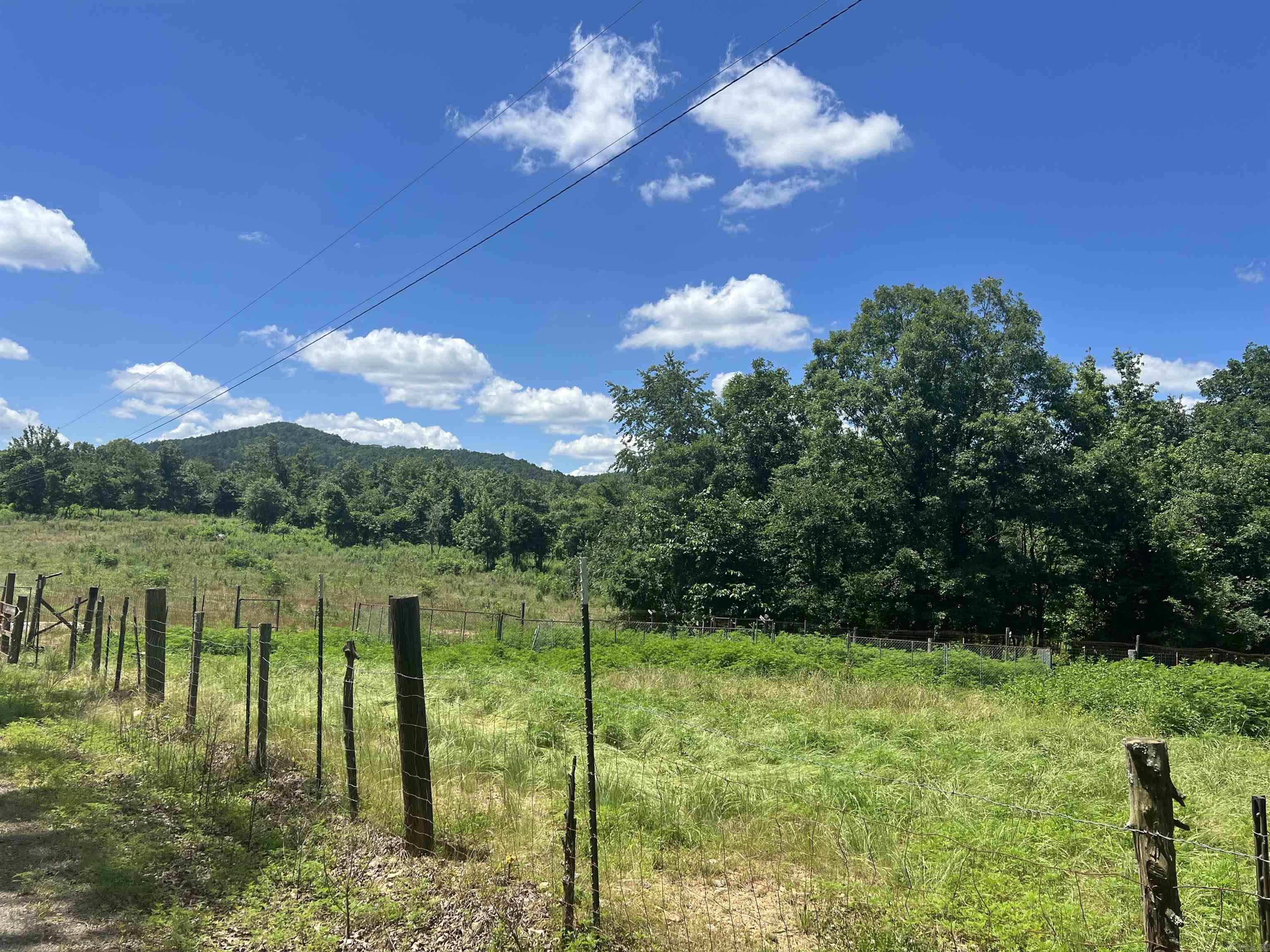 An incredible opportunity to own 56.44 Acres+/- of private land. This property offers: National Forest on three sides access to thousands of acres of public land. Small year round creek located at the back of the property. Utilities in place. Well, Electric, and septic already installed. 8" fence most all the way around the property. Mobile home (no assigned value) a partially completed cabin, and a prime building site ready for your dream home or retreat. Riding trails all along the way. Formerly known as the Circle T Fox Pen, This land is rich with potential for recreational, residential, or agricultural use. Whether you're looking to build, hunt,farm,or just escape into nature, This is a rare find.